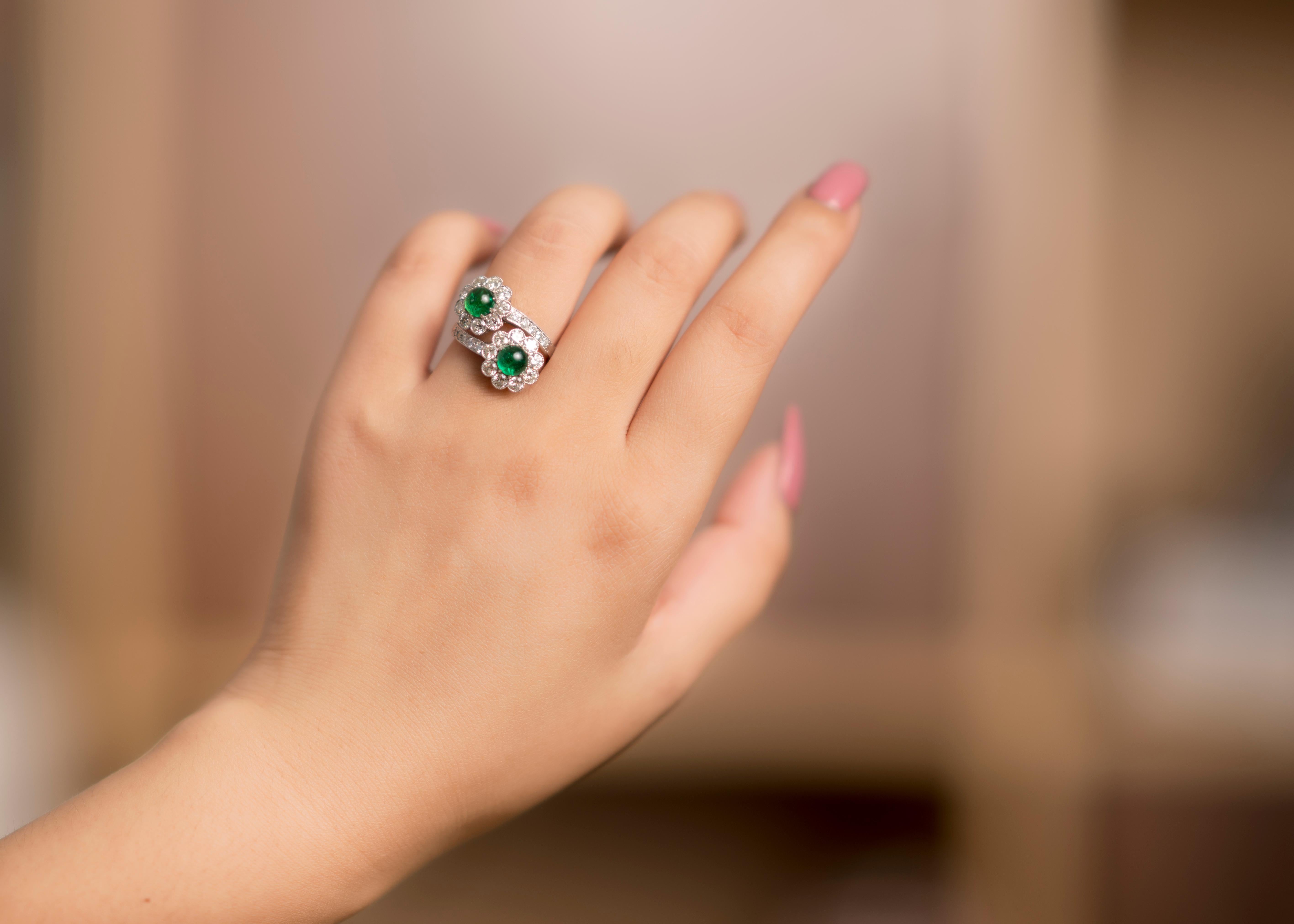 This wonderful cross-over ring made from 18 Karat white gold wraps your fingers with two flower heads crafted from emeralds against bright and lively diamonds with a total emerald carat of 1.3 and diamond carat of 1.36.

The emeralds are a vivid