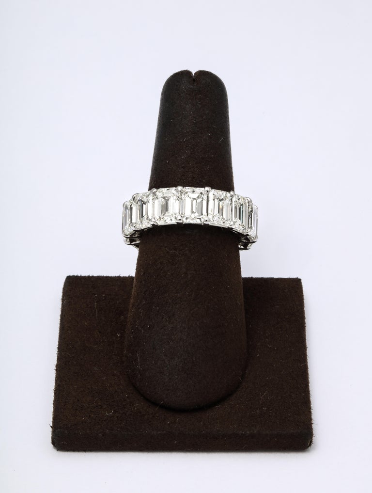 
A beautiful eternity band -- full of sparkle!  

13.07 carats of white emerald cut diamonds set in a custom platinum mounting.

The diamonds have the measurements of carat size stones — the ring measures 7.1 mm wide. 

Currently a size 6.5, this