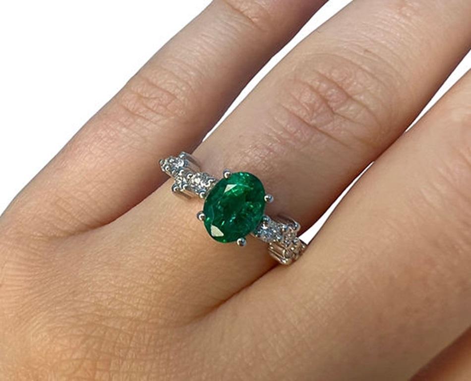 Emerald Weight: 1.31 CTs, Measurements: 8x6 mm, Diamond Weight: 0.20 CTs, Metal: 18K White Gold, Gold Weight: 3.41 gm, Ring Size: 6.5, Shape: Oval, Color: Intense Green, Hardness: 7.5-8, Birthstone: May