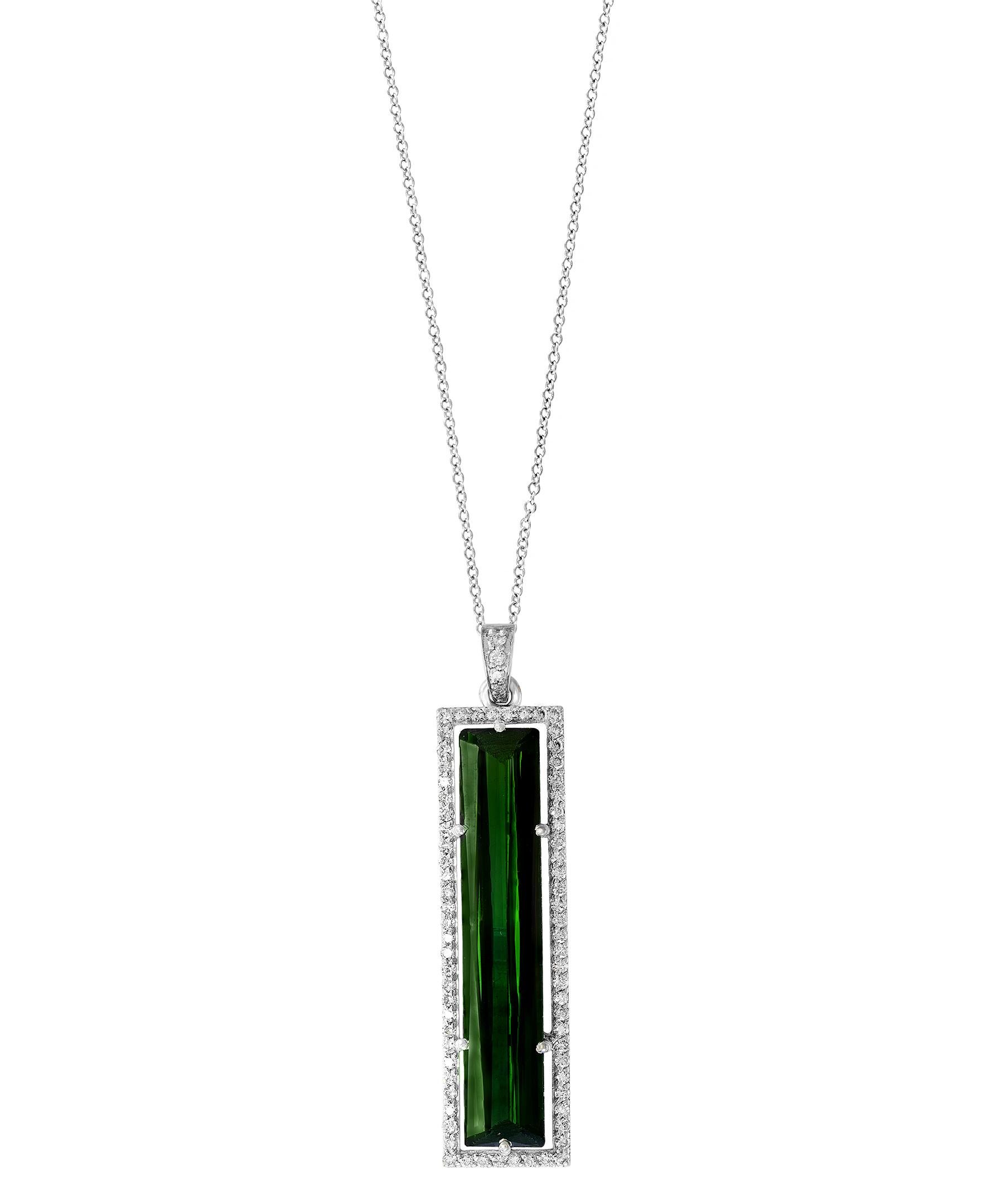   13 Carat Green Tourmaline  & Diamond Pendant /  Necklace 18 Karat  Gold.
This spectacular Pendant Necklace  consisting of a single long Cushion  Shape Green Tourmaline Approximately   13 Carat.  The  Green Tourmaline  is surrounded by