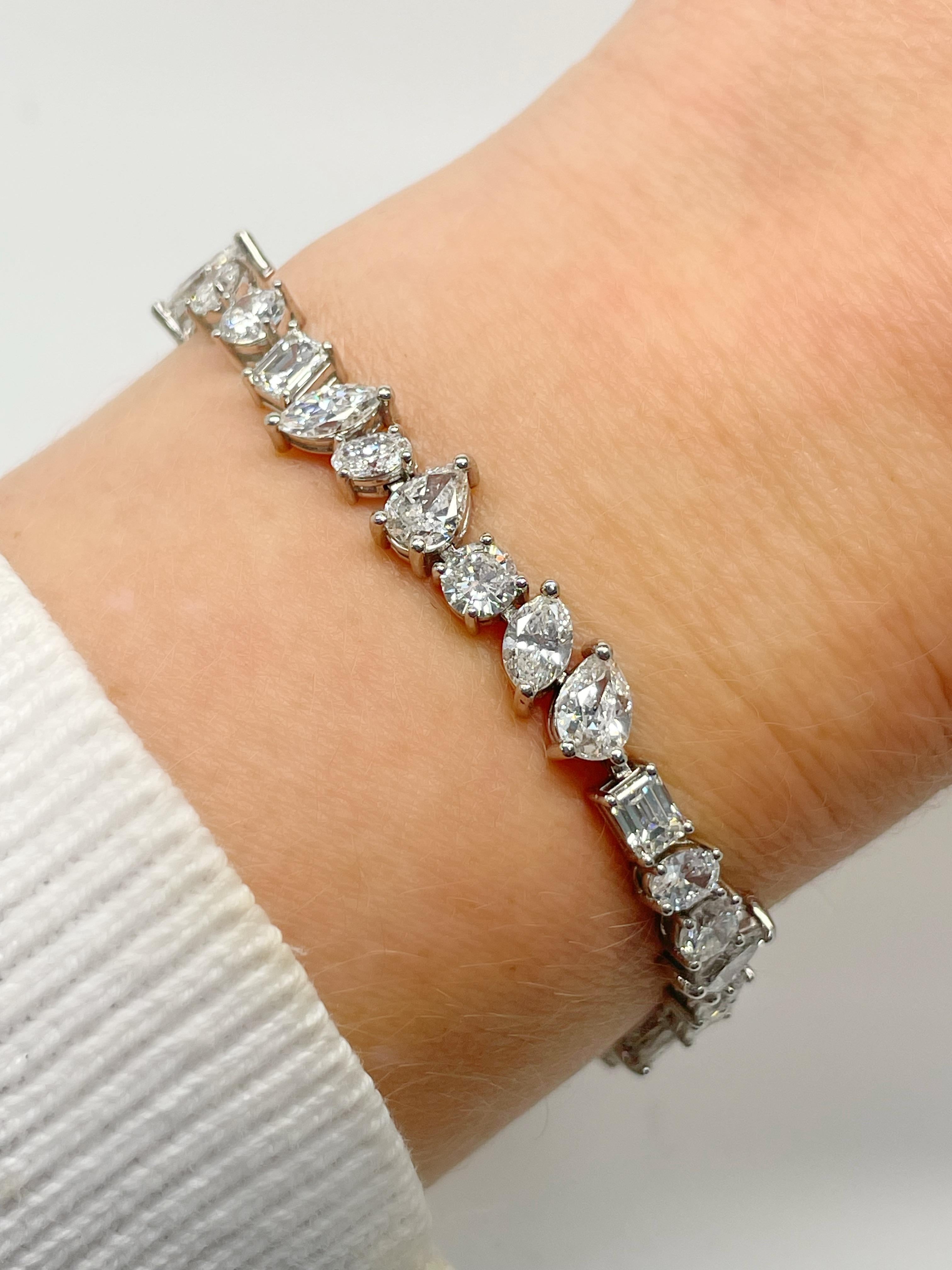 This super classic bracelet contains 39 pear, emerald, marquise, oval and round brilliant cut diamonds weighing approximately 13.00 carats total. Crafted in platinum, this bracelet is extremely well made and a perfect addition to your