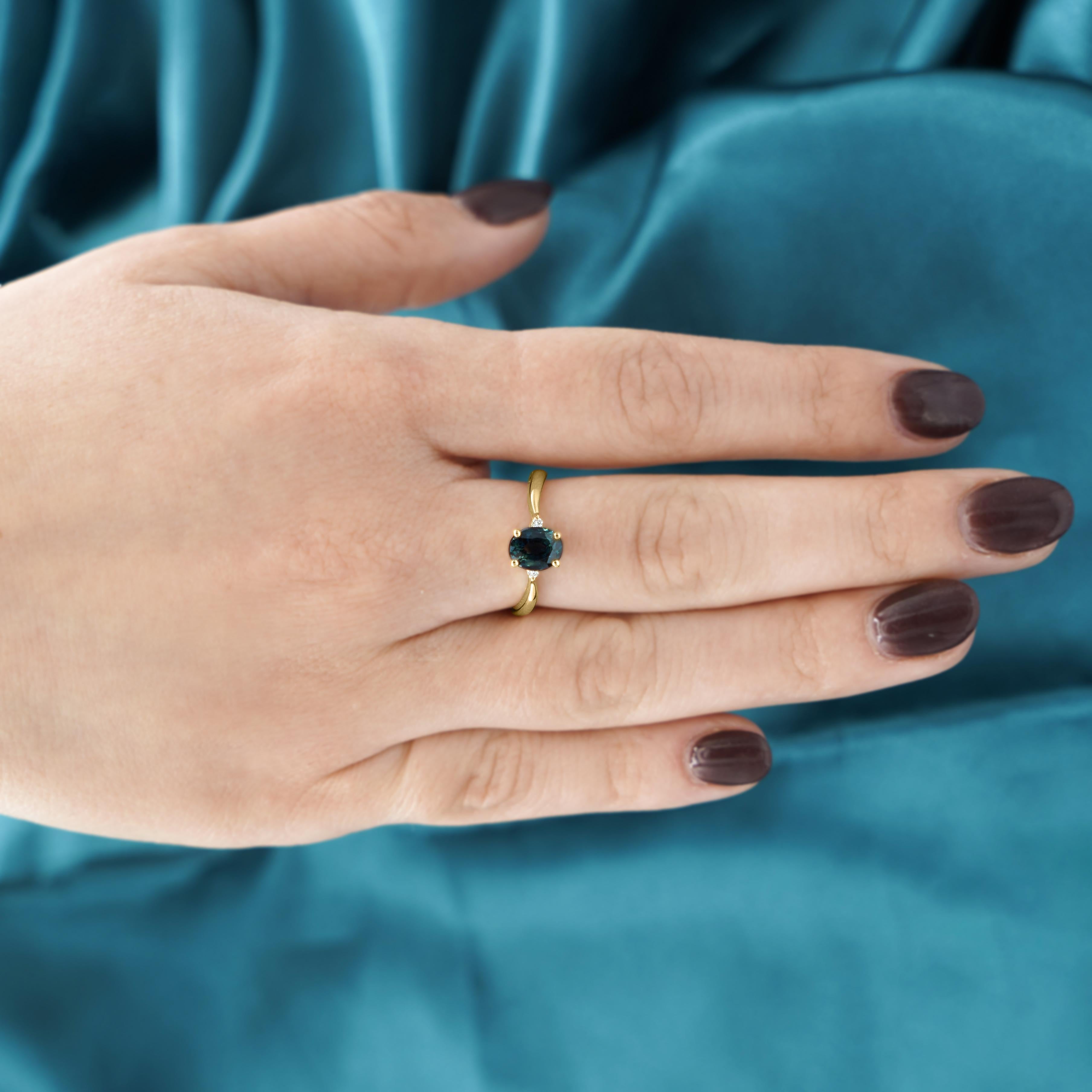 A timeless 3-stone ring featuring a rich blue sapphire center flanked by delicate round cut diamond accents, set in a curved 14K yellow gold band with 2mm width for an effortlessly elegant look.

Details:
Item Type: 3-Stone Ring
Metal: 14K Yellow