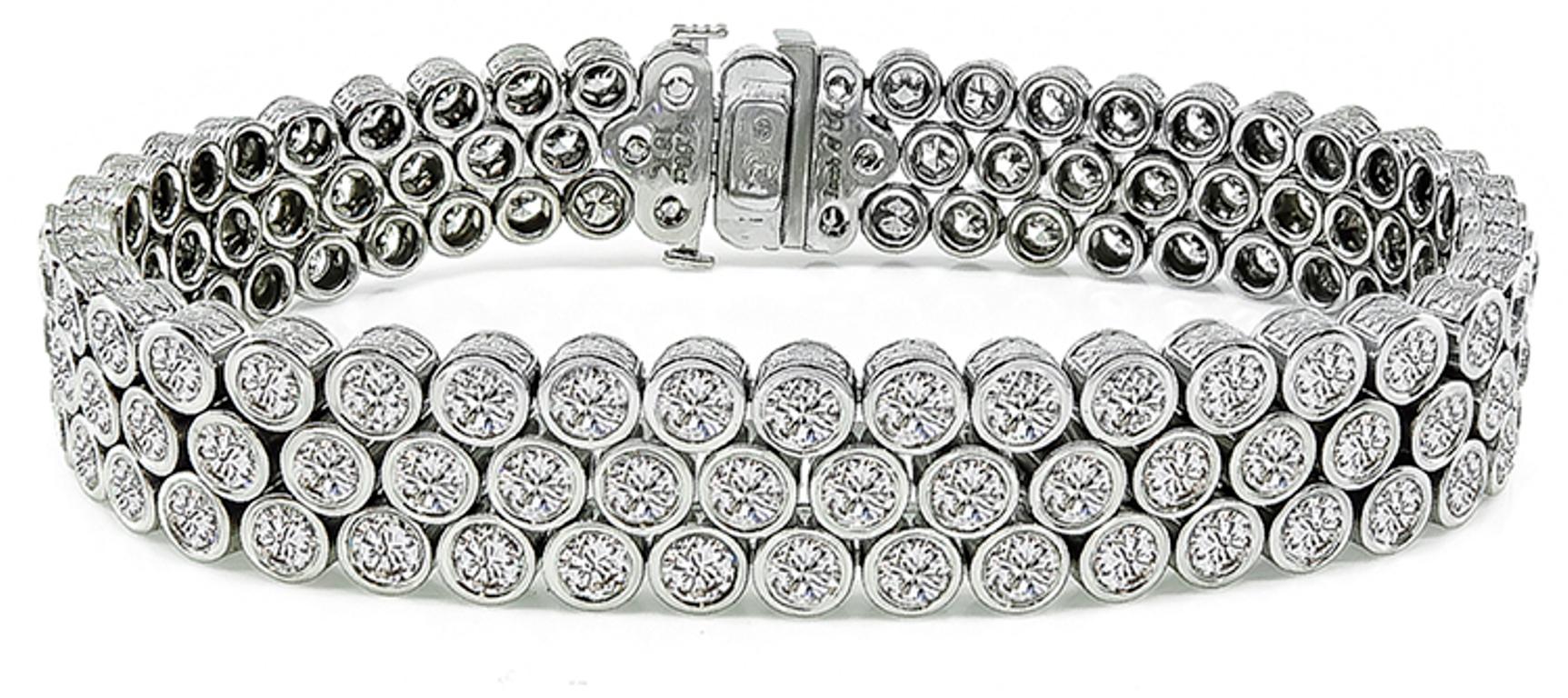 This 18k white gold bracelet by Jacobs & Co. is set with sparkling round cut diamonds that weigh 13.00ct. graded G color with VS clarity. The bracelet measures 7 inches in length and 11mm in width. The bracelet is stamped Jacobs & Co 13.00ct 18K 750