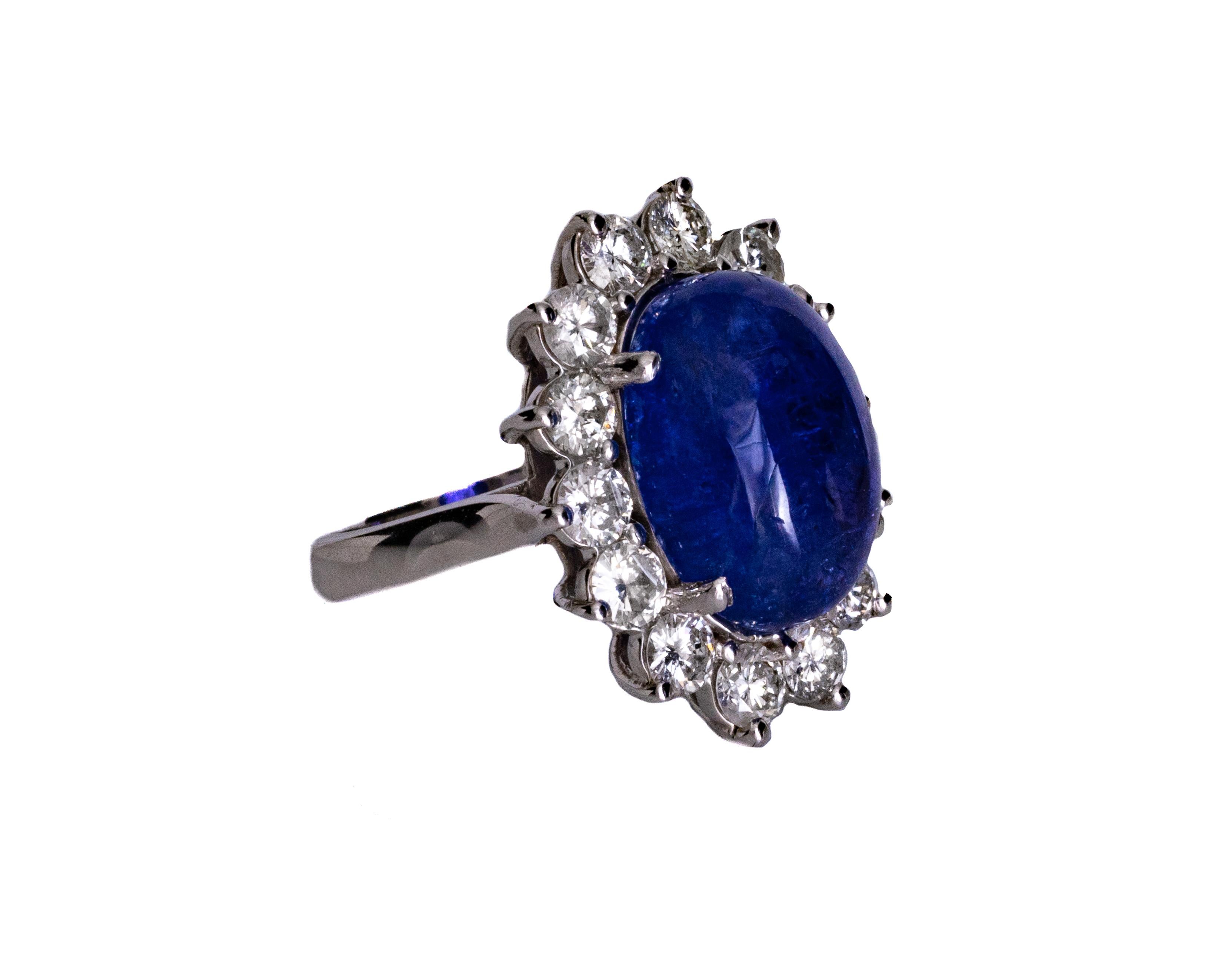 Ring Details:
Metal type: 14 Karat White Gold
Weight: 11.34 grams
Ring Size: 7.5 

Diamond Details:
Carat: 3.4 Carat Total
Cut: Round Brilliant
Color: G-H
Clarity: VS-I1

Tanzanite Details:
Carat: 13 Carat
Cut: Oval Cabochon
Color: Blue

Absolutely