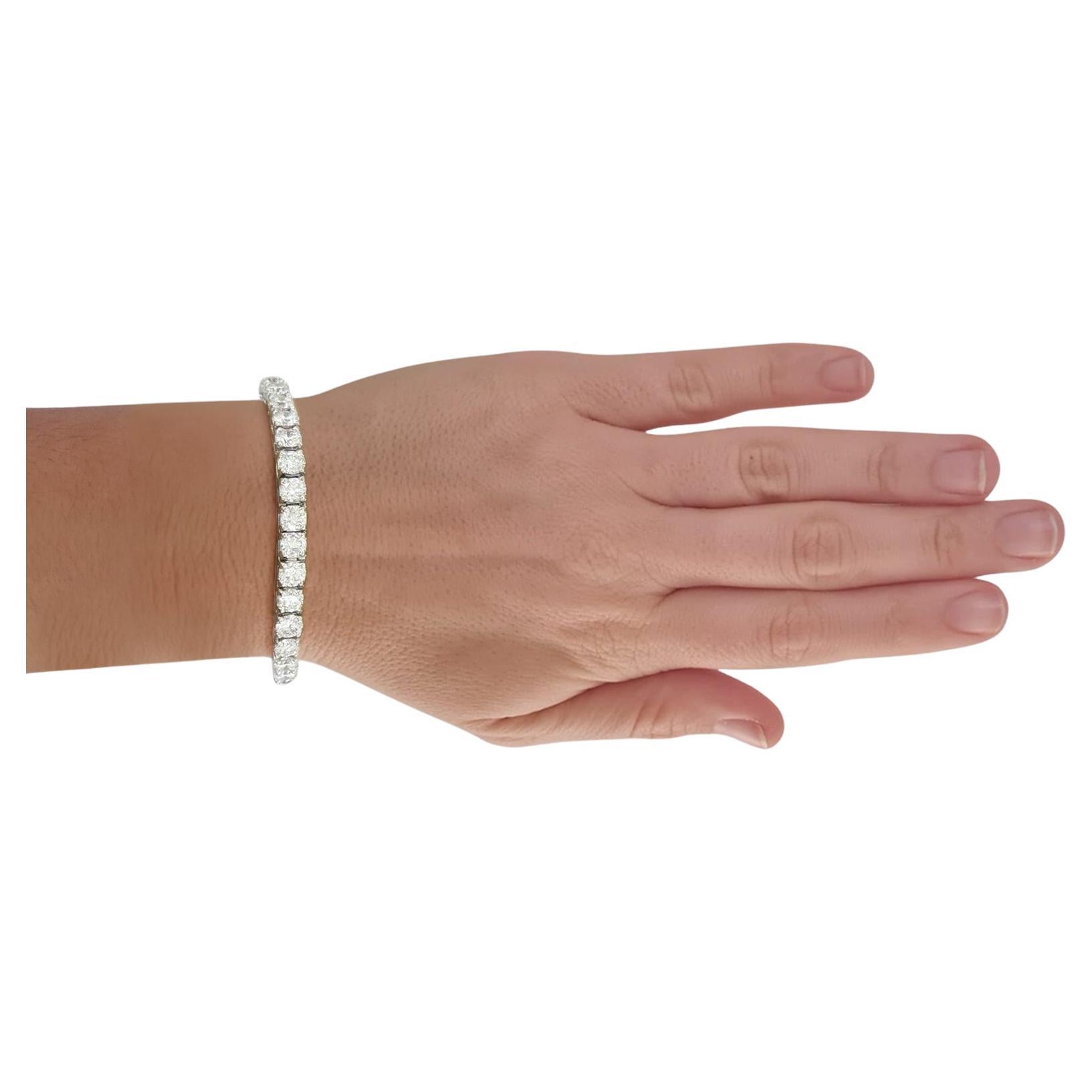 Indulge in the epitome of luxury with our stunning 13-carat White Gold Round Brilliant Cut Diamond Tennis Bracelet. This masterpiece seamlessly marries timeless elegance with contemporary allure, making it a radiant addition to any jewelry