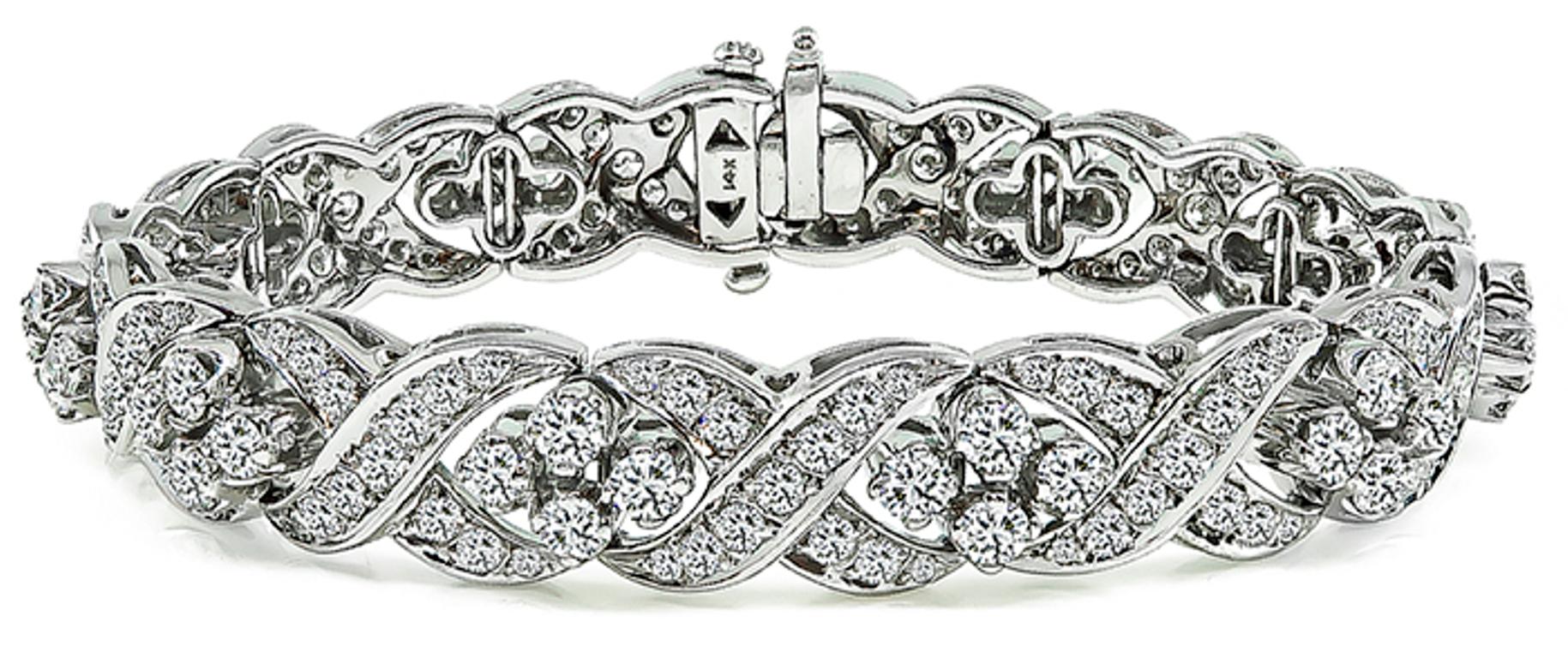 This fabulous 14k white gold bracelet is set with sparkling round cut diamonds that weigh approximately 13.00ct. graded G color with VS clarity. The bracelet measures 7 1/4 inches in length and 11mm in width.
It is stamped 14K and weighs 37.9