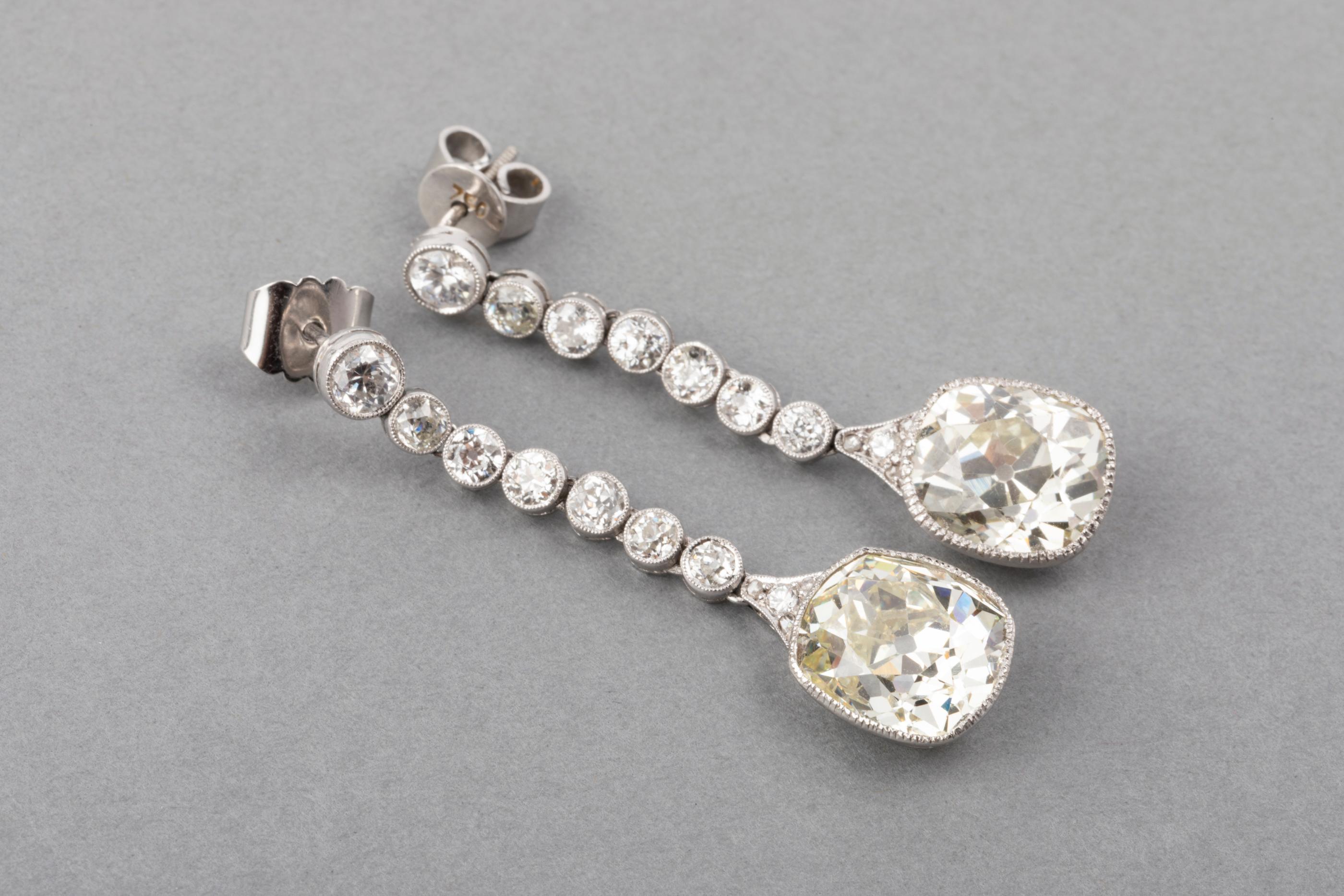 13 Carats Diamonds French Art Deco Earrings

Very beautiful pair or earrings, made in France circa 1920.
They are elegant. 
The two principal cushion cut diamonds weights 5.65 and 5.45 carats exactly. 
The colour is L/M estimate and Vs1 clarity. The