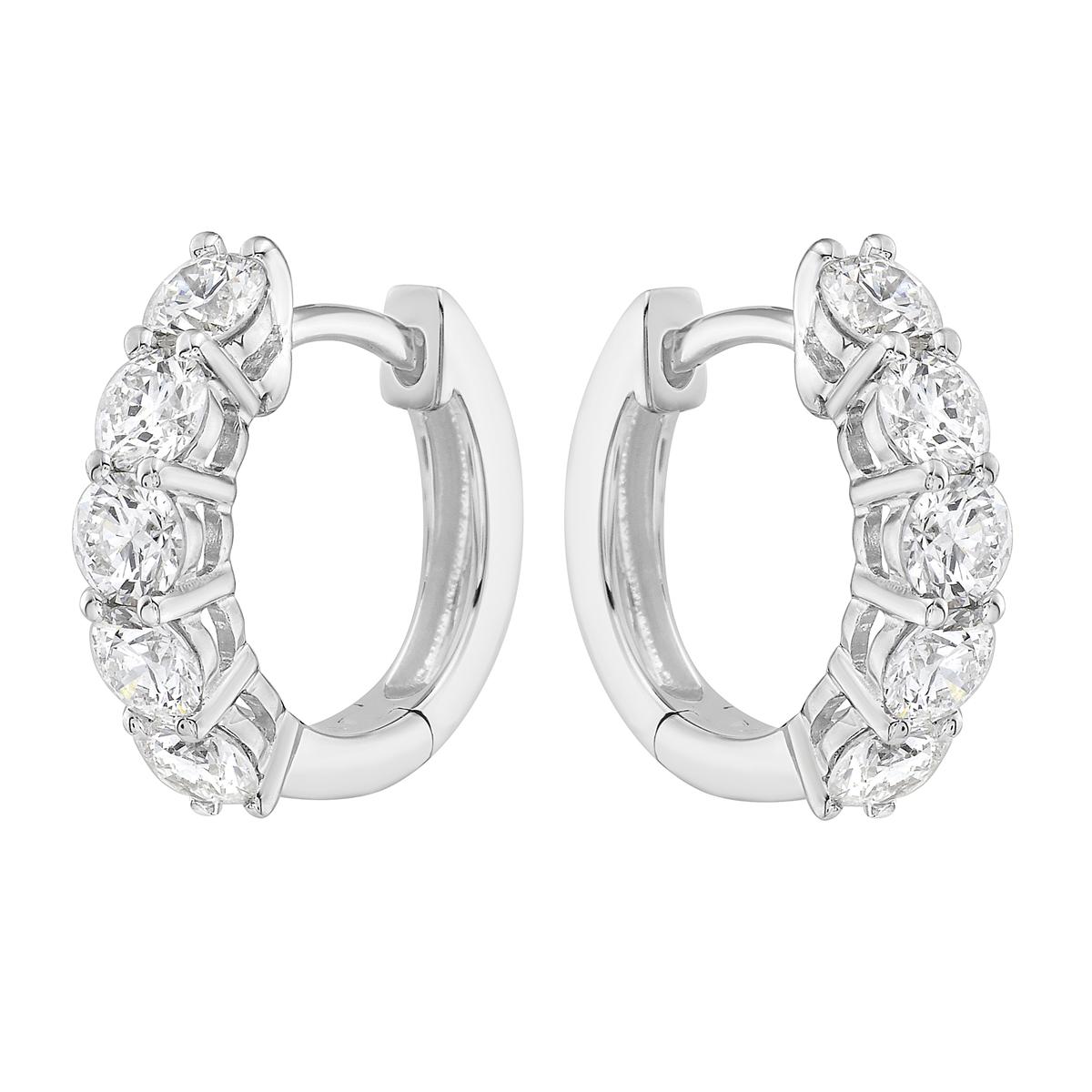 With these exquisite white-gold diamond hoops, style and glamour are in the spotlight. These hoops are set in 18-carat gold, made out of 3.1 grams of gold. The color of the diamonds is G. The clarity is VS2. These earrings are made out of 10