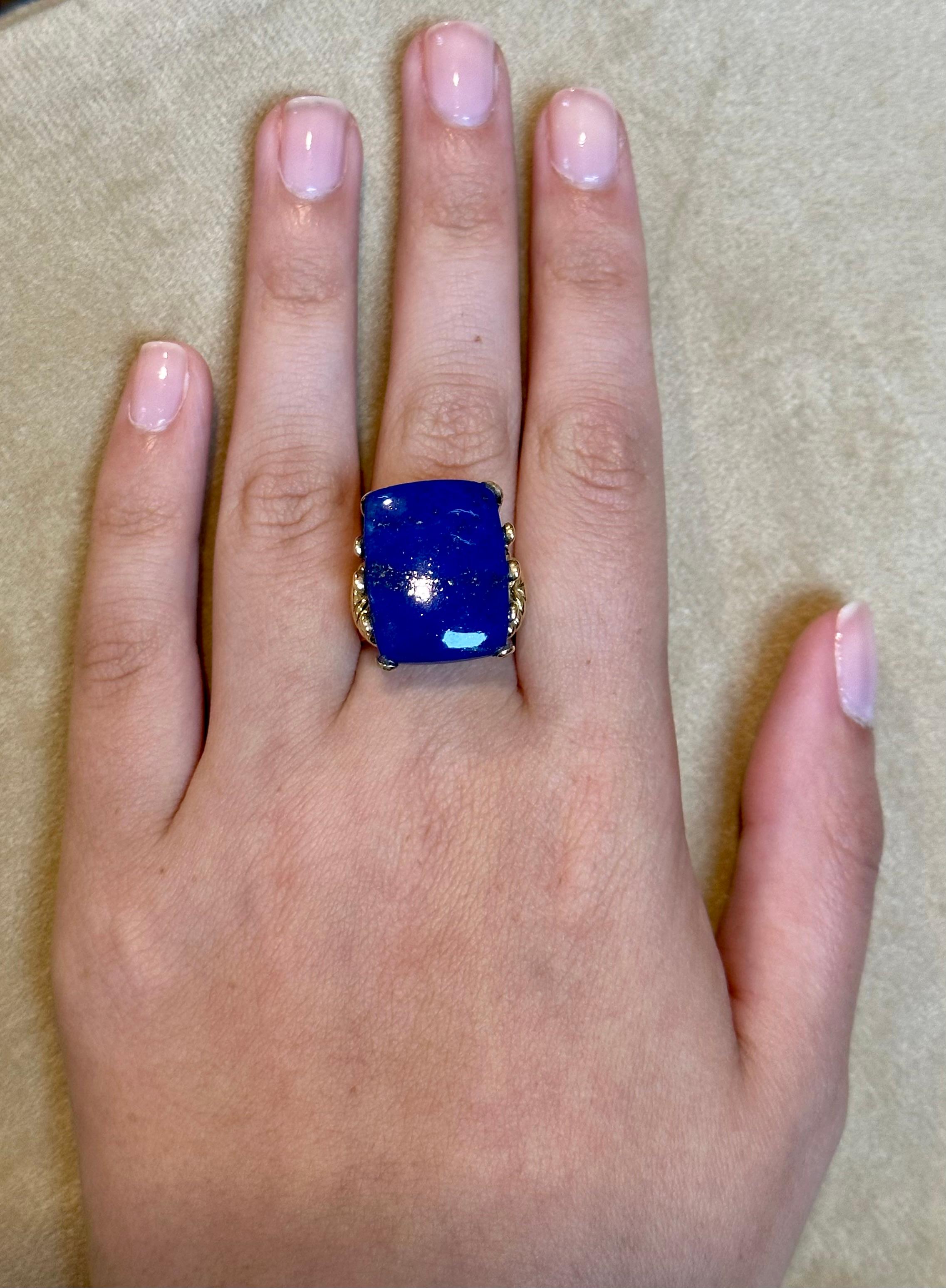 Introducing our exquisite Estate Lapis Lazuli Ring, crafted in 14 Karat Yellow Gold. This stunning ring features a magnificent 13 carat, high-quality, natural Lapis Lazuli gemstone in an Emerald cut shape. The color, cut, and clarity of the stone