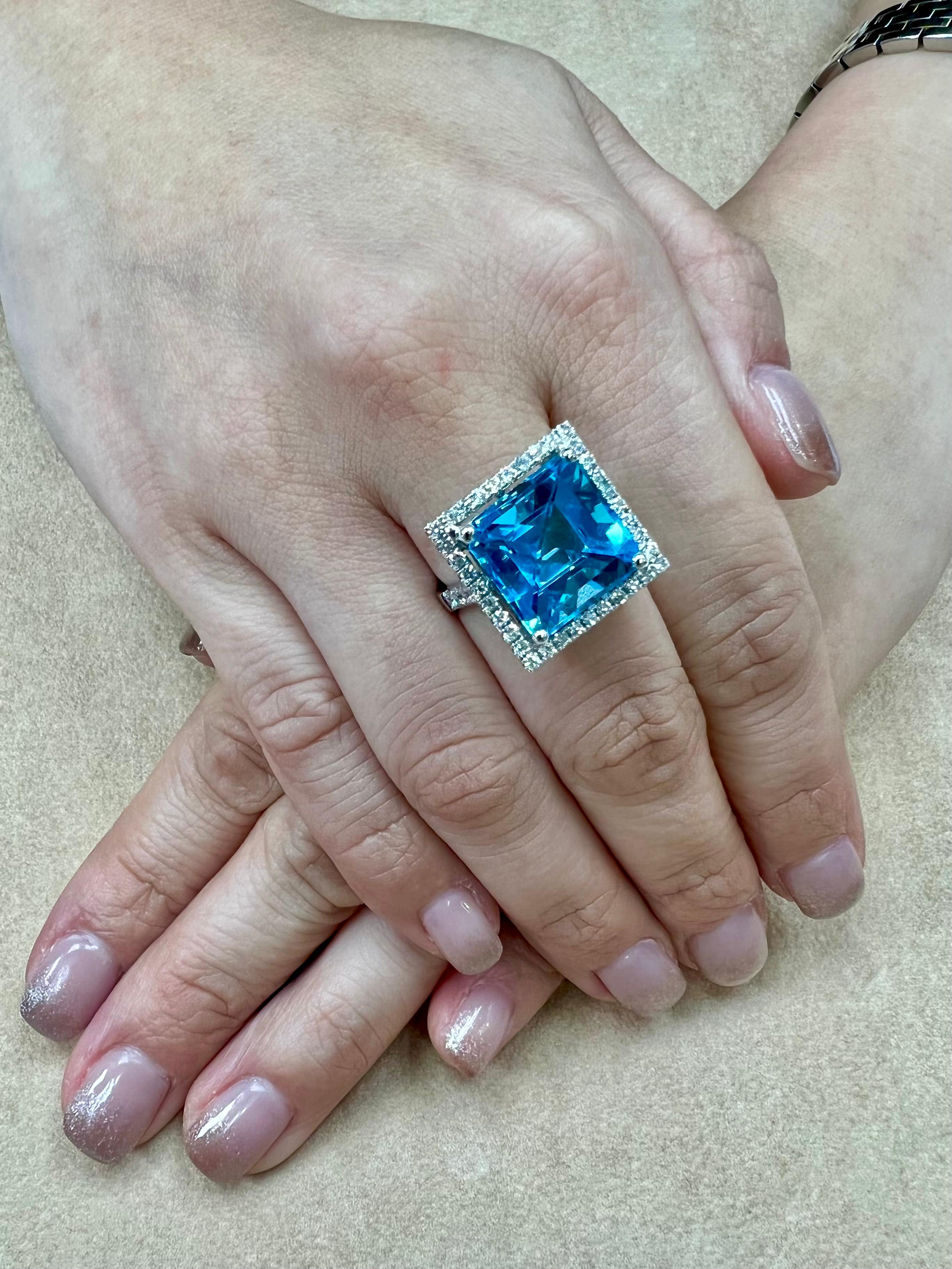 Please check out the HD video! Here is a super nice checker square cut blue Topaz and diamond cocktail statement ring. It is set in 18k white gold. The 13.76 cts center Topaz is stunning. The checker cut is spectacular. The color is an eye catching