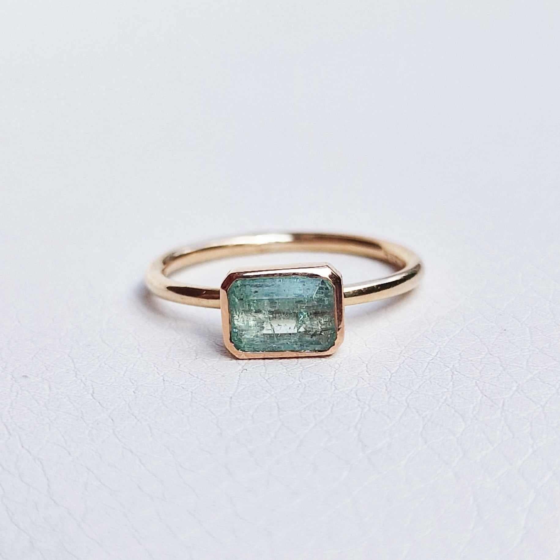 A beautiful and classic electric emerald ring in solid peach-yellow gold. The ring could be an original choice for an engagement and will be especially loved by women who appreciate colored gemstones. 

Ring is available in size 53 / 6.5 / M1/2 and