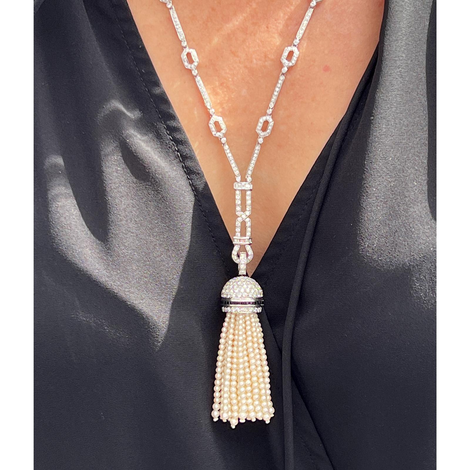 Stunning diamond link necklace with detachable diamond, pearl, and onyx tassel fashioned in 18 karat white gold. The necklace measures 21 inches in length and features round brilliant cut diamonds weighing approximately 7.50 CTW and graded G-H color