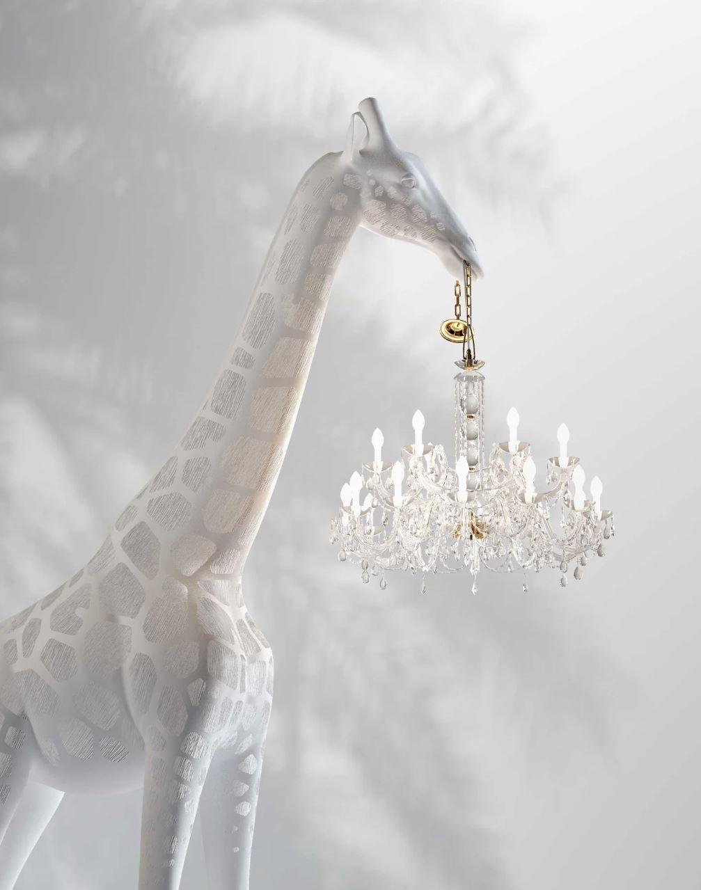 Introducing Giraffe in Love, one of the most unique, extravagant, and eye-catching chandeliers you'll ever encounter. Created by Italian designer Marcantonio Raimondi Malerba, this 13-foot tall giraffe holds a classic Marie-Thérèse chandelier in its