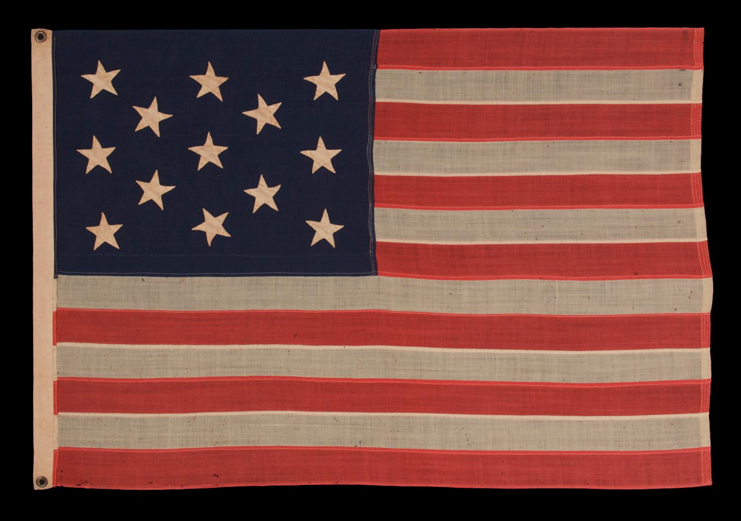 13 HAND SEWN STARS IN A 3-2-3-2-3 PATTERN ON A U.S. NAVY SMALL BOAT ENSIGN OF THE CENTENNIAL ERA, CIRCA 1870-1882:

Despite the fact that America hasn't been comprised of 13 states since 1791, 13 star flags have been made and displayed throughout