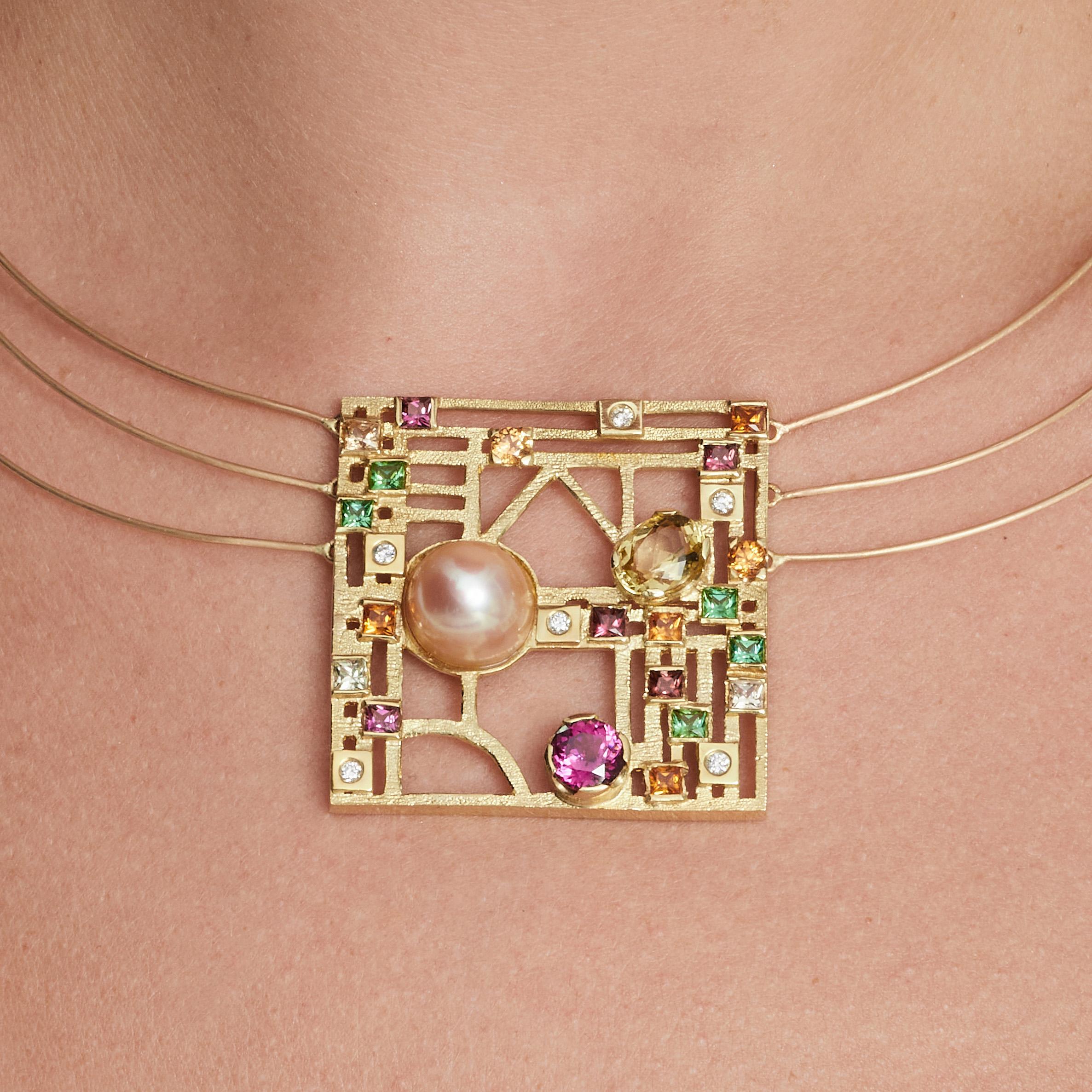 This 18-karat yellow gold necklace with a brushed finish has three twisted gold wire chains with a lobster clasp. The necklace features a 13-millimeter cultured South Sea pearl, a 1.84-carat citrine, 1.78 carats of garnet, 0.783 carats of green