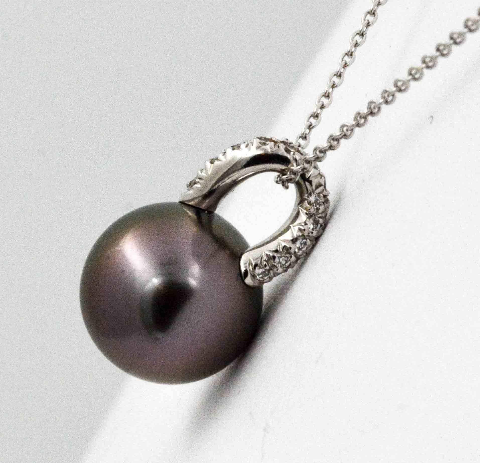 An enchanting 13 mm black Tahitian pearl ornamented with white gold is endlessly versatile. The 18 karat white gold bail is U-shaped and has 30 pave set diamonds 0.22 carat total weight (G-H color and VS internal clarity). This spectacular Tahitian