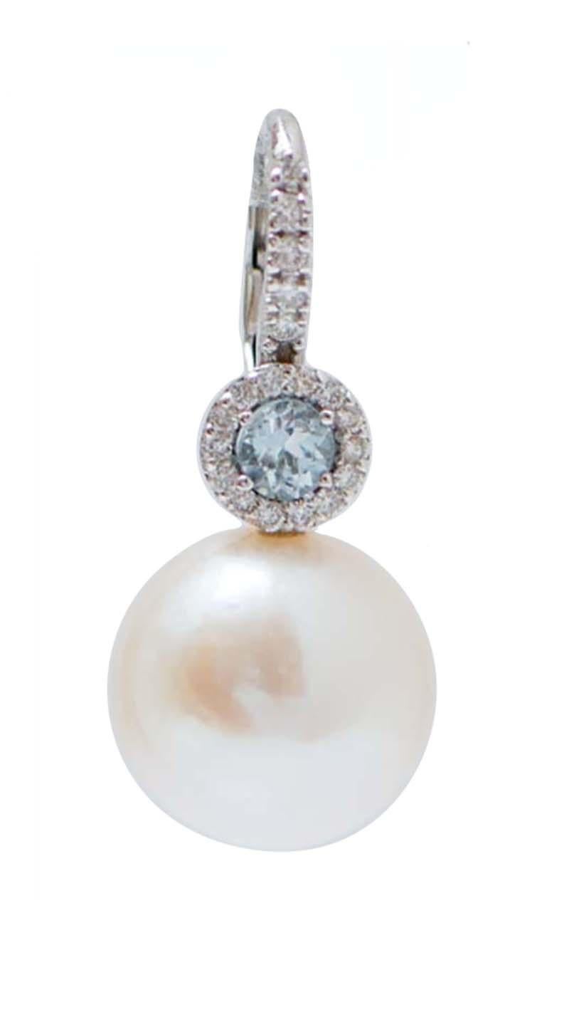 Elegant modern earrings in 18 kt white gold structure mounted with diamonds and a topaz. Below, a pearl.
Diamonds 0.50 ct
Topazs 0.62 ct
Pearls 6.20 gr - 13 mm
Total Weight 8.80 gr
 RF    G   UGCC
RK.AOGI

For any informations, feel free to contact