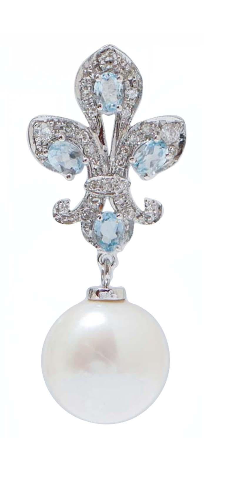 Amazing earrings in 14 kt white gold structure mounted with diamonds and, between of them, topaz. As pendant, a white  pearl.
These earrings were totally handmade by Italian master goldsmiths and they are in perfect conditions.
Diamonds 0.70