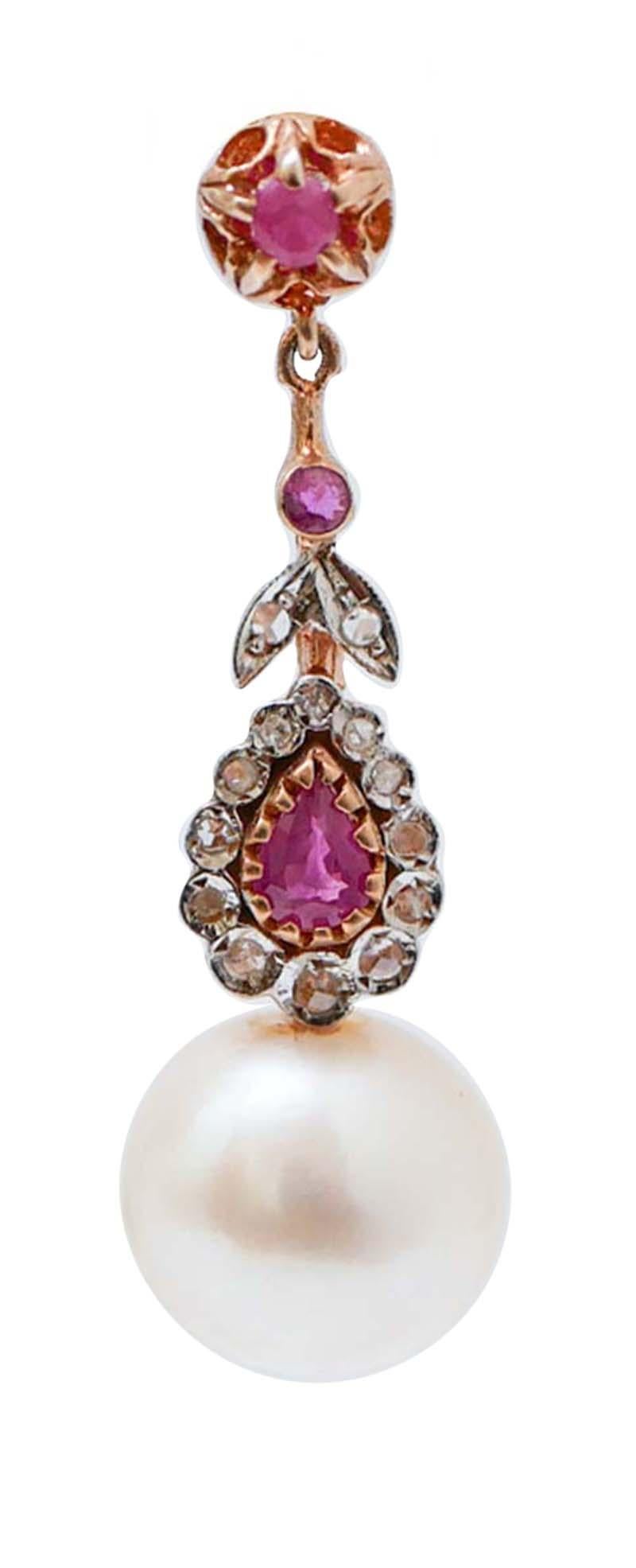 Dangle earrings in 9 kt rose gold and silver structure mounted with diamonds and rubies  along the length of the earring and a white pearl as pendant.
Diamonds 0.20 ct
Rubies  1.58 ct
Pearls 6.40 gr
Total Weight 10.90 gr
RF *GUFF

For any