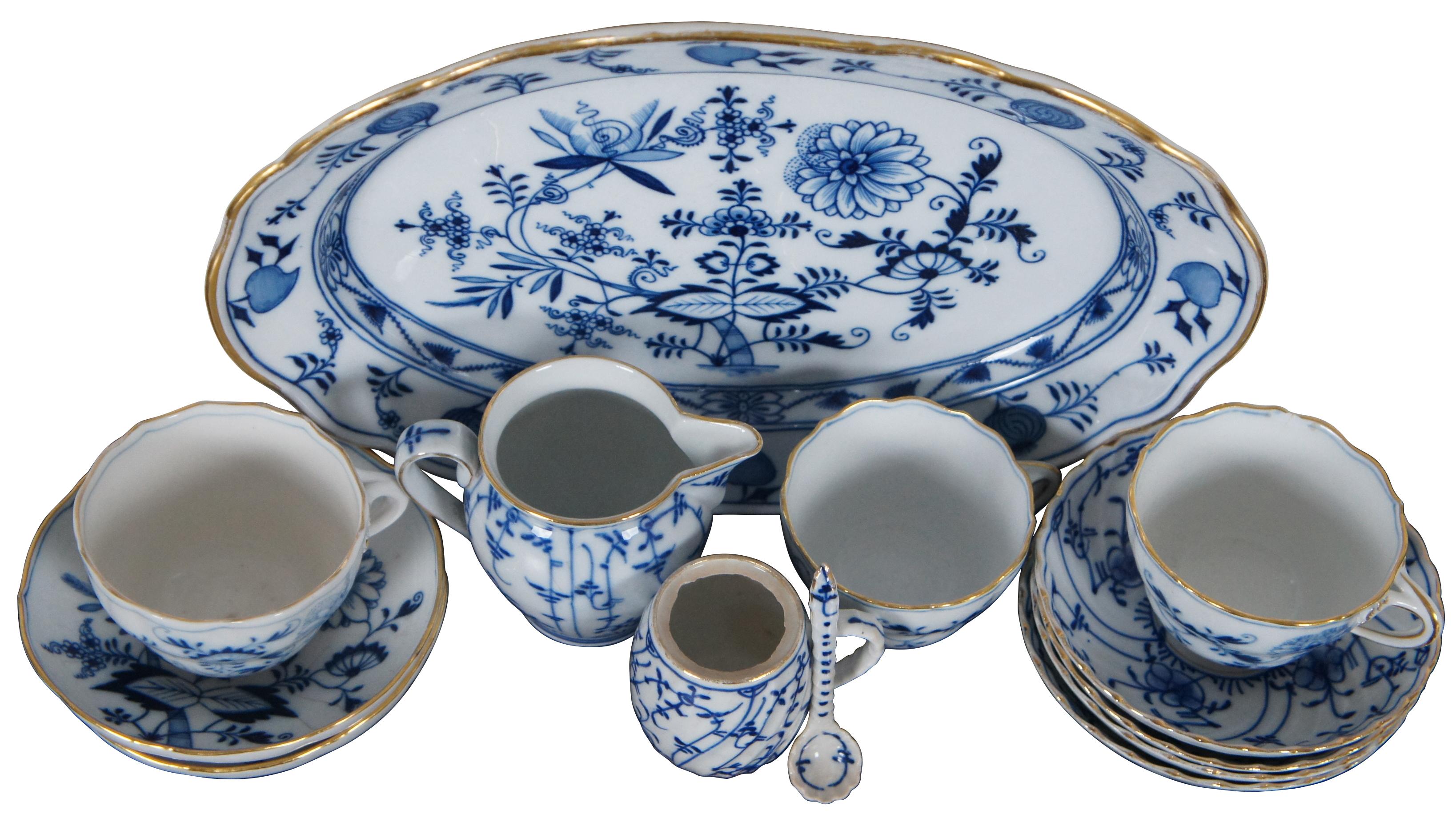 Lot of thirteen 19th century dinnerware pieces by Meissen and Königlich privilegierte Porzellanmanufaktur Tettau, Sontag & Maisel (1879–1902), featuring blue and white Blue Onion patterns and gilded accents.

Measures: Oval platter - 13” x 9.5” x