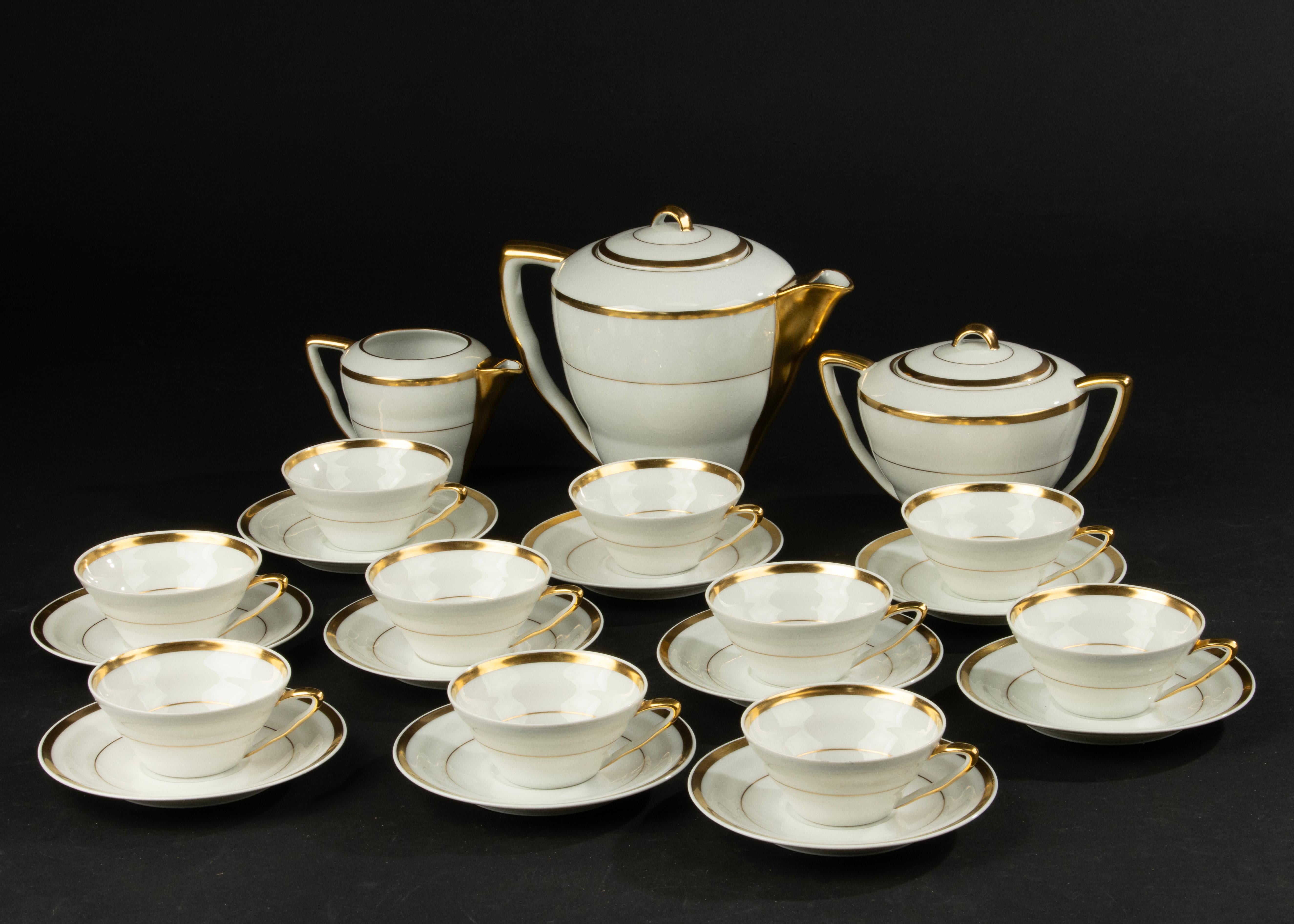 A sweet porcelain tea set, for 10 people, made by the French brand Limoges.
This service was made around 1930, the design has clear Art Deco features.
The color scheme white with gold is classic French Limoges.
The composition of the set is as