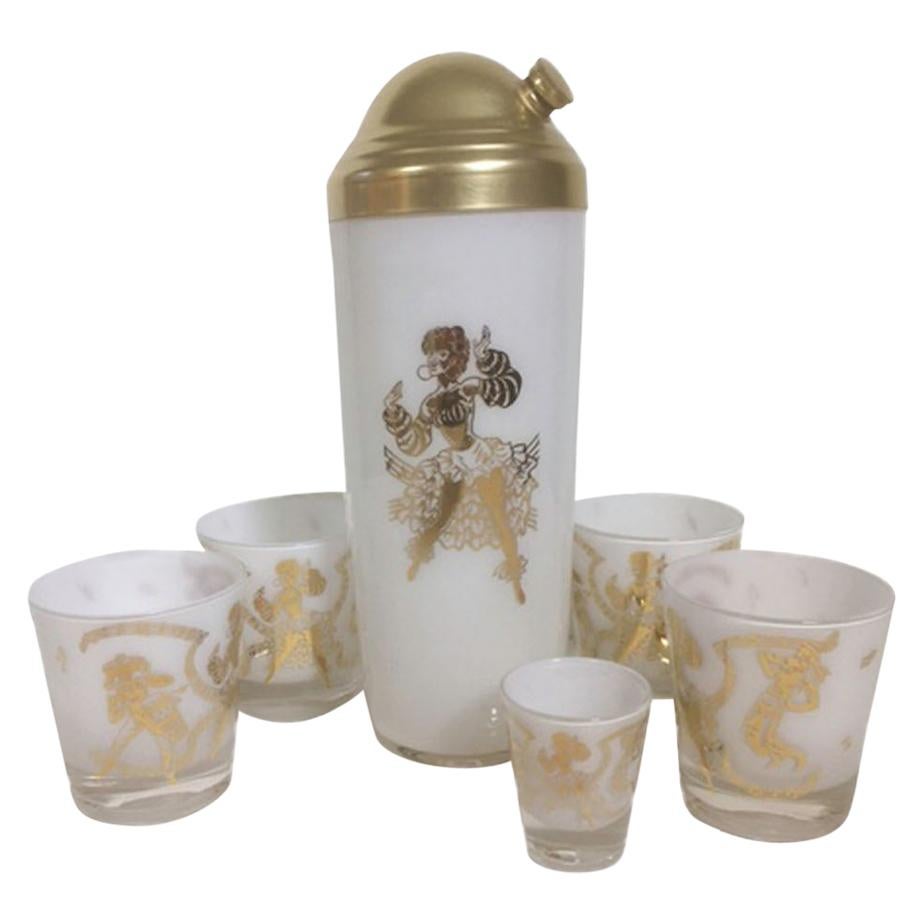 Thirteen piece vintage barware set, clear glass with white frosted interiors having an image of a 3 piece Calypso band in 22 karat gold. All in excellent condition.

1 - Cocktail shaker with gold-tone lid: 10-3/4