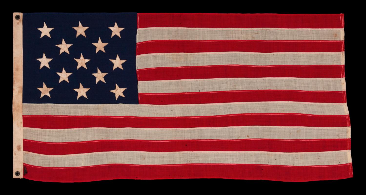 13 stars arranged in a 3-2-3-2-3 pattern on a small-scale flag of the 1890s-1910s era, with an attractive, elongated profile

This 13 star antique American flag is of a type made during the last decade of the 19th century through the first quarter