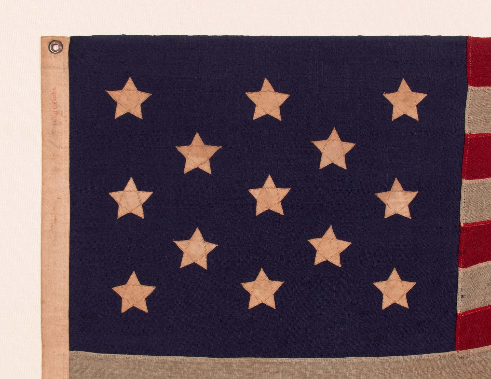 13 STARS WITH SHORT, CONICAL ARMS ON A SMALL SCALE, ANTIQUE AMERICAN FLAG MADE DURING THE LAST DECADE F THE 19TH CENTURY; POSSIBLY OF PHILADELPHIA ORIGIN; FORMERLY IN THE COLLECTION OF BOLESLAW & MARIE D'OTRANGE MASTAI, THE FIRST MAJOR COLLECTORS TO