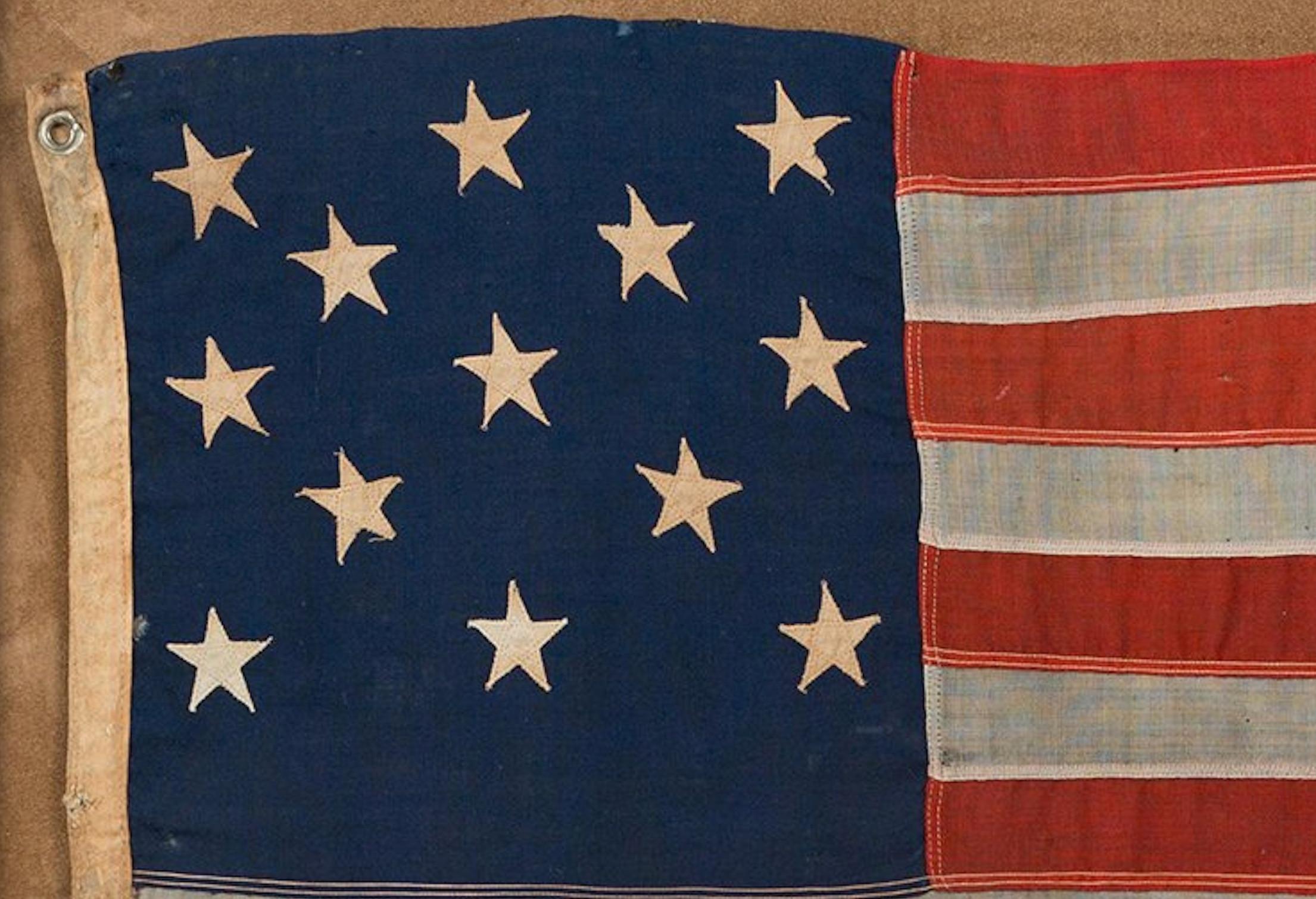 Presented here is a 13-star American flag, circa 1890-1910. The stars are arranged in rows of 3-2-3-2-3, which is the most recurring pattern of 13-star flags in the late 19th and early 20th centuries.

The 3-2-3-2-3 pattern, which looks like a
