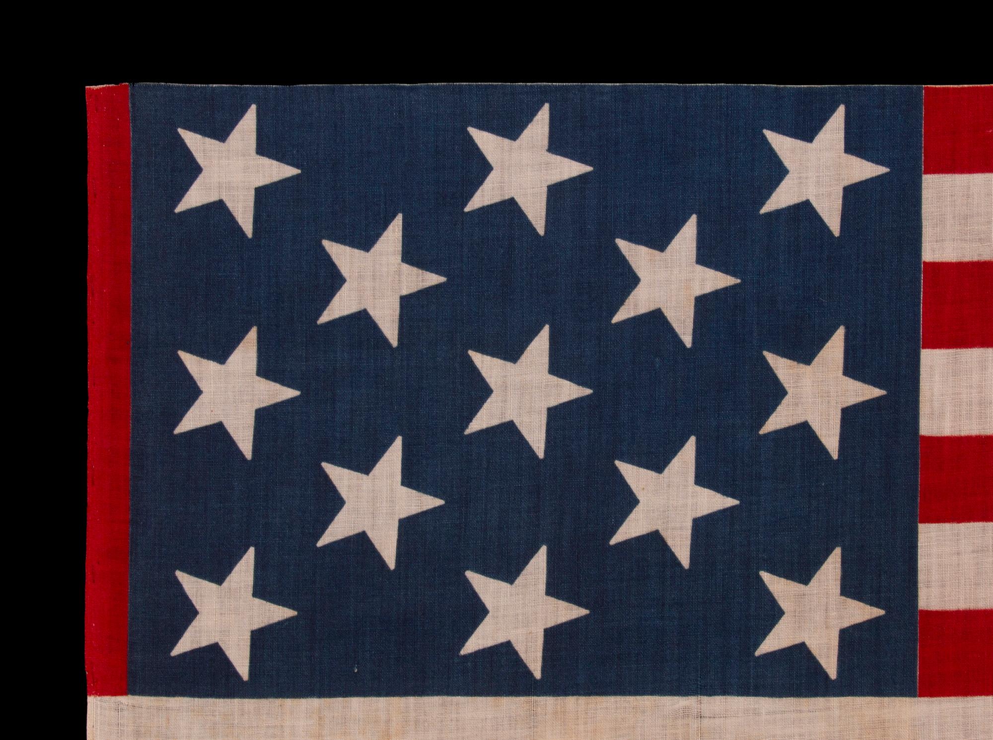 13 STAR ANTIQUE AMERICAN PARADE FLAG, WITH A 3-2-3-2-3 CONFIGURATION OF STARS, AN EXTREMELY SCARCE AND UNUSUALLY LARGE VARIETY, MADE circa 1876-1899

13 star American national parade flag, printed on cotton, made sometime during the last quarter of
