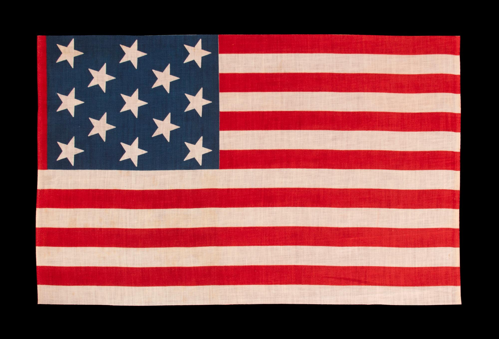13 star antique American parade flag, with a 3-2-3-2-3 configuration of stars, an extremely scarce and unusually large variety, made circa 1876-1899:

13 star American national parade flag, printed on cotton, made sometime during the last quarter