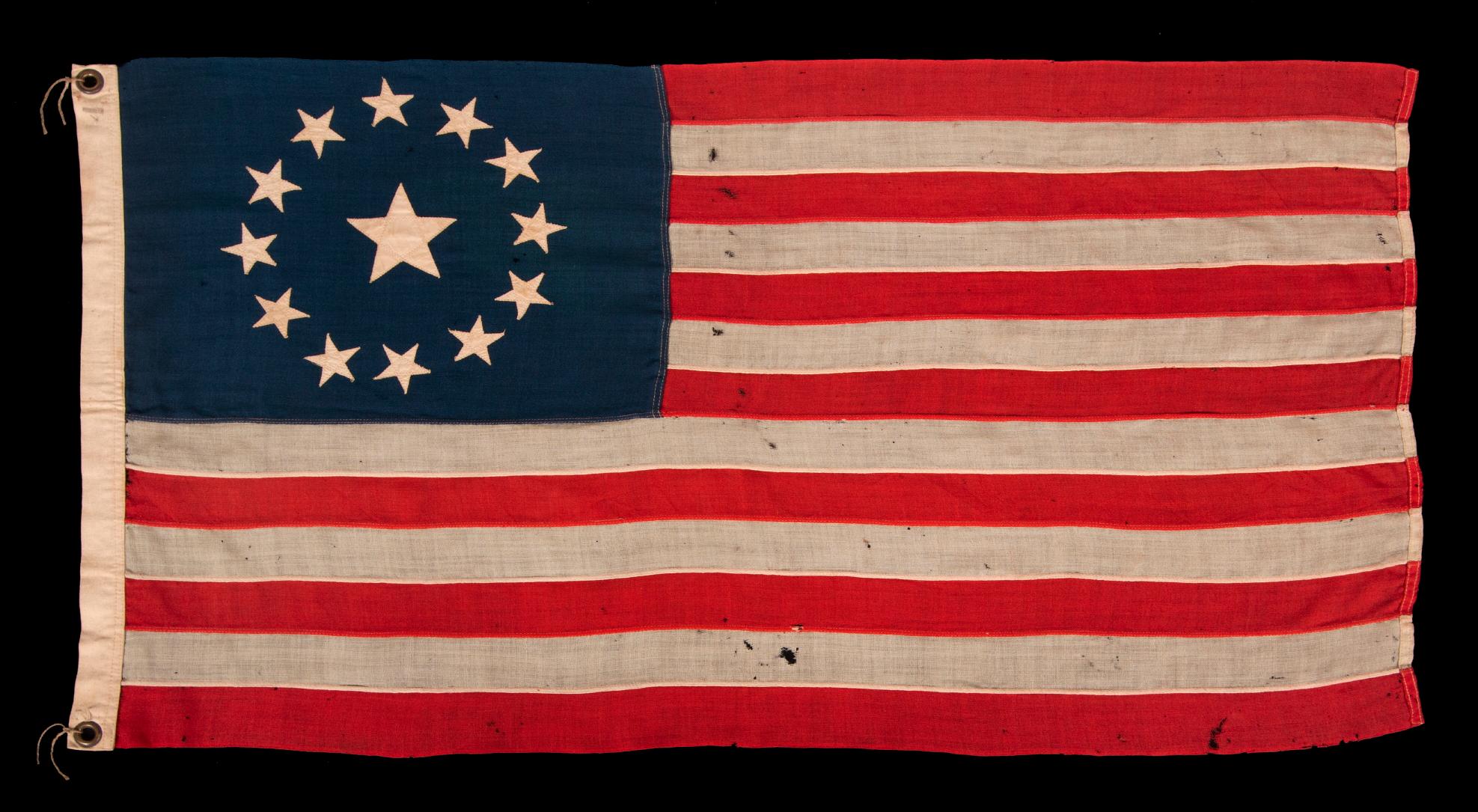 13 star antique American flag, with a circular arrangement of what is known as the 3rd Maryland pattern, on a small scale example with beautiful, elongated proportions and an unusually large center star, made circa 1890-1900

13 star flags have