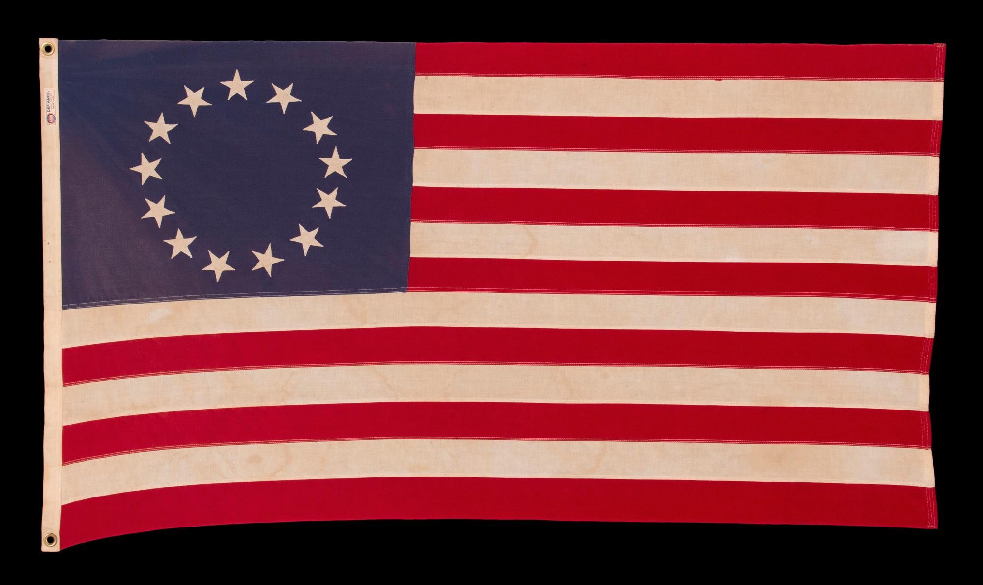 13 STARS IN THE BETSY ROSS PATTERN, ON A VINTAGE AMERICAN FLAG, MADE BY THE ANNIN COMPANY OF NEW YORK & NEW JERSEY, circa 1955 - 1965

13 star American national flag, made entirely of cotton by the Annin Company of New York & New Jersey, in the