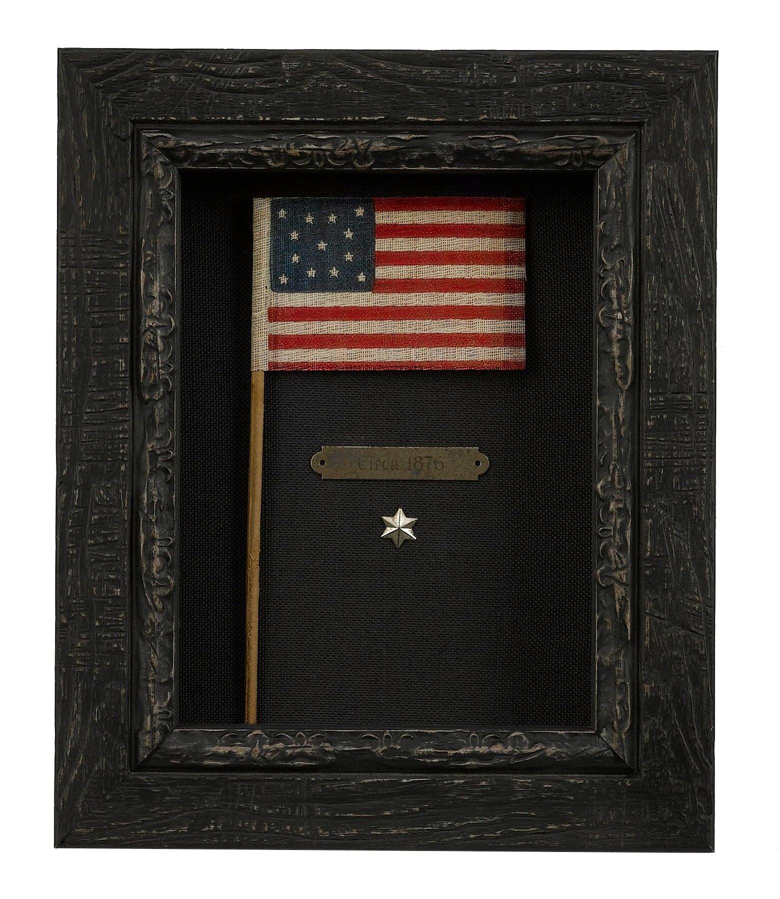 This small charming 13-star flag waver was made for and sold during the nation’s Centennial celebration in Philadelphia in 1876. All manner of flags were made for the official Centennial International Exposition, which was a World’s Fair event of