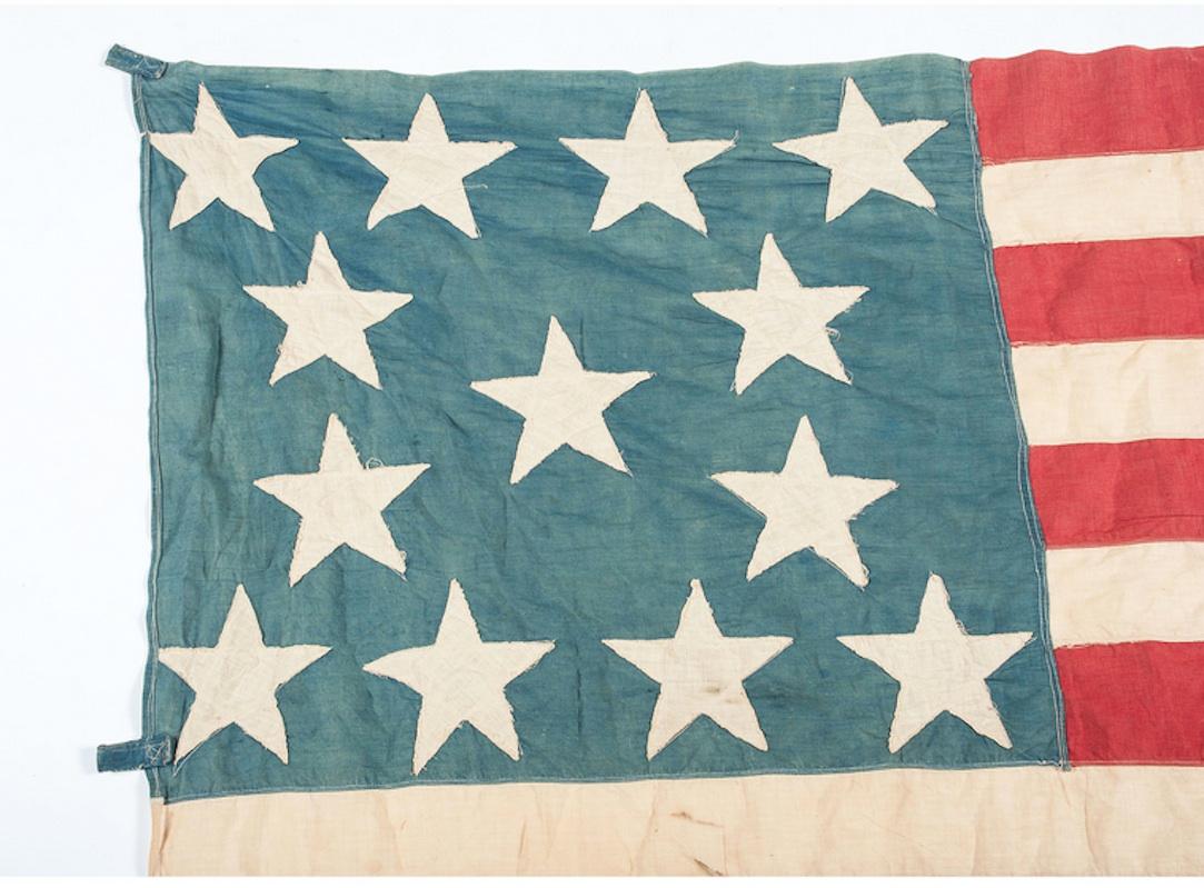 This is a cotton, machine-sewn flag with 13 double-appliqued stars. The canton of this flag has stars arranged in a highly desirable medallion pattern, with a single circle of eight stars surrounding a central star. There are also four stars in the