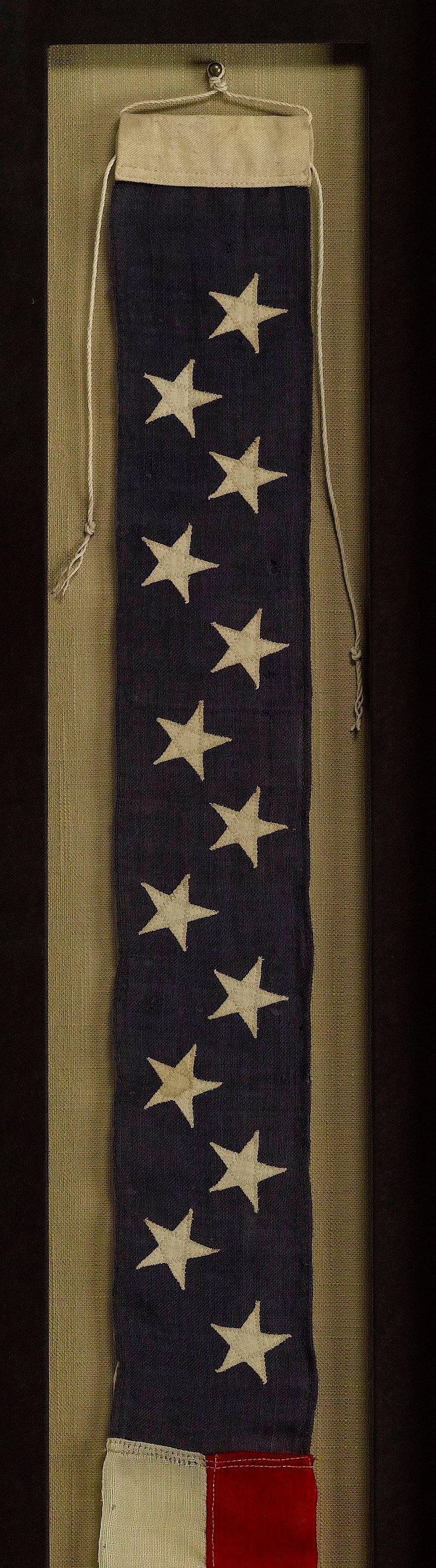 This is a 13-Star Naval Commissioning Pennant, circa 1880-1890. A naval commissioning pennant is flown at all times as long as a ship is in commissioned status, except when a flag officer or civilian official is embarked and flies his personal flag