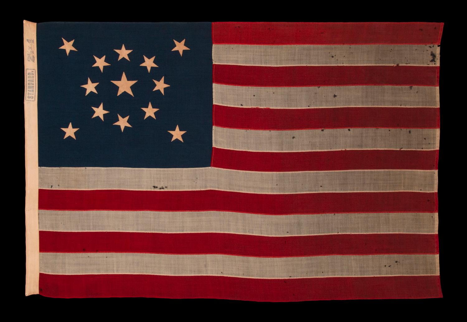 13 STARS IN A MEDALLION CONFIGURATION ON A SMALL-SCALE ANTIQUE AMERICAN FLAG OF THE 1895-1926 ERA, MARKED 