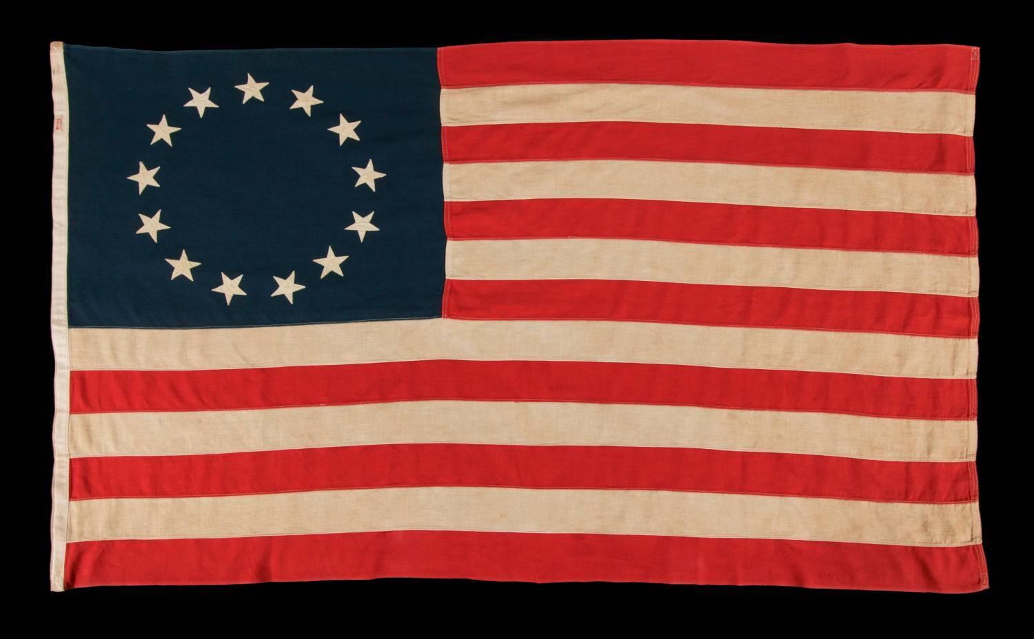13 STARS IN THE BETSY ROSS PATTERN, MADE BY ANNIN IN NEW YORK CITY, A SCARCE SEWN EXAMPLE IN A DESIRABLE SMALL SCALE, 1914-1930:

 13 star American national flag, made in the period between approximately 1914 and 1930. The stars are arranged in the