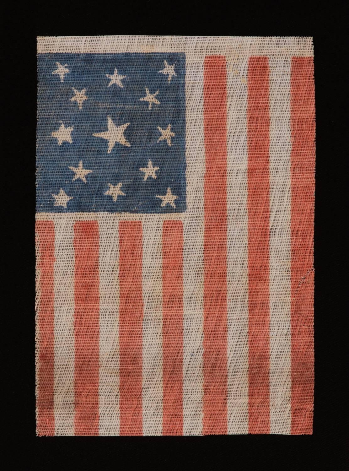 13 STARS IN A MEDALLION PATTERN ON AN ANTIQUE AMERICAN PARADE FLAG, MADE FOR THE 1876 CENTENNIAL OF AMERICAN INDEPENDENCE; A SCARCE EXAMPLE AMONG ITS COUNTERPARTS, WITH NICE FOLK QUALITIES:

13 star American national parade flag, printed on coarse,