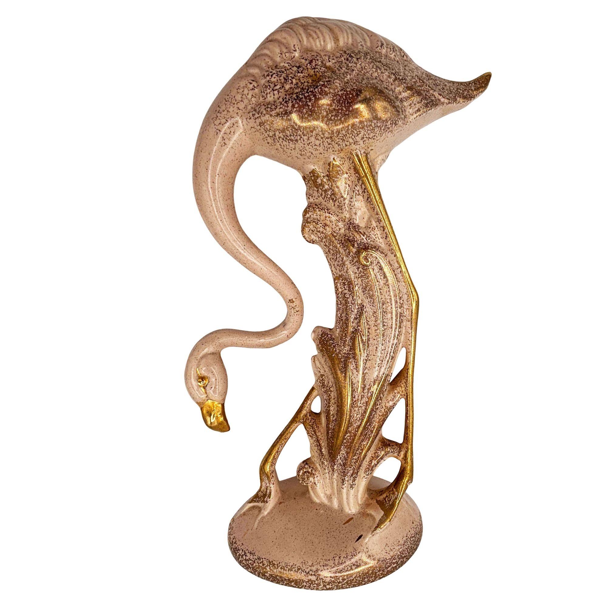 Rare 1970s Modernist light pink and gold long-legged flamingo ceramic figurine. The statue detailed a pink flamingo with long legs, a slim, tall form standing on a grassy field. It comes in a gloss finish that highlights the rich light pinks and