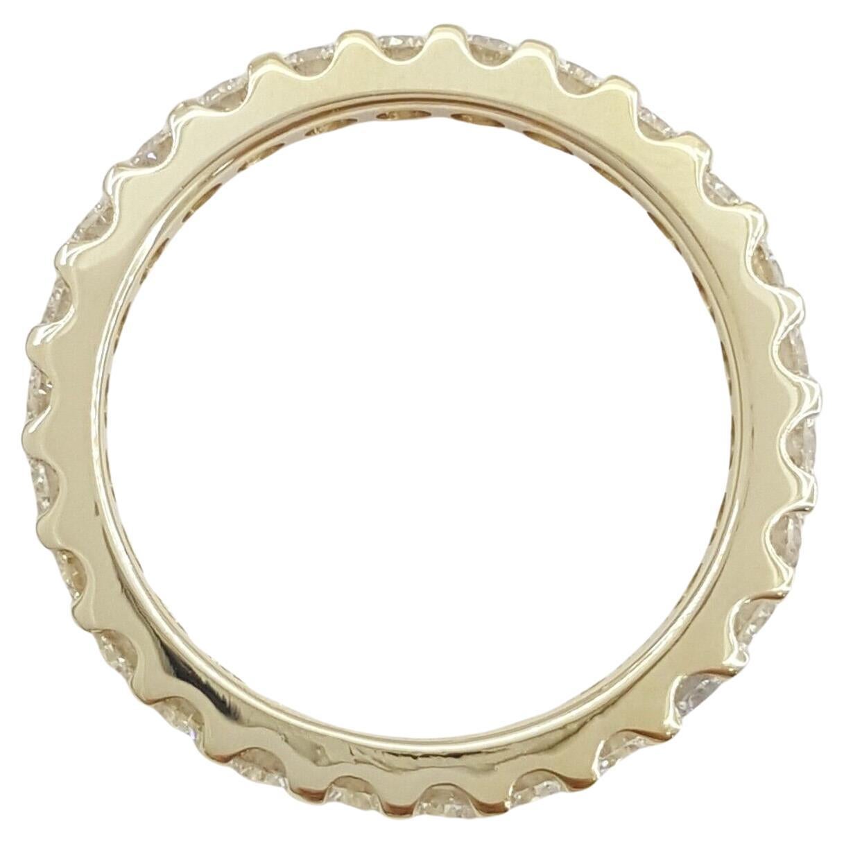 Introducing a stunning 14K yellow gold eternity band, elegantly set with round brilliant cut diamonds totaling 1.3 carats. This timeless full-circle design symbolizes eternal love, making it the perfect choice for a wedding band, anniversary ring,