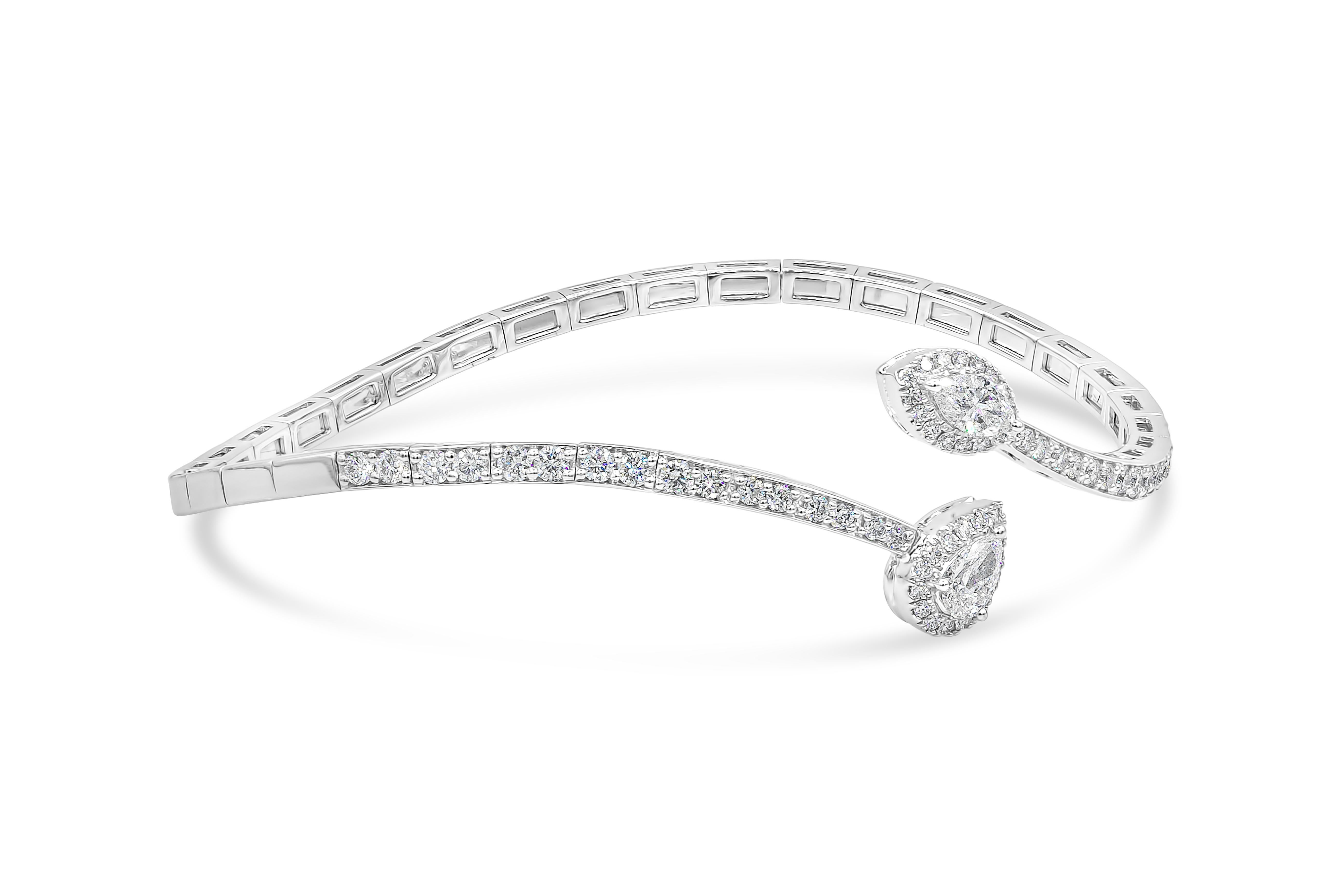 A unique and fashionable cuff bracelet showcasing a wave design set with brilliant diamonds. On the end of the cuff is a pear shape diamond halo, and a marquise cut diamond halo. Diamonds weigh 1.30 carats total. Made with 14K White Gold

Style