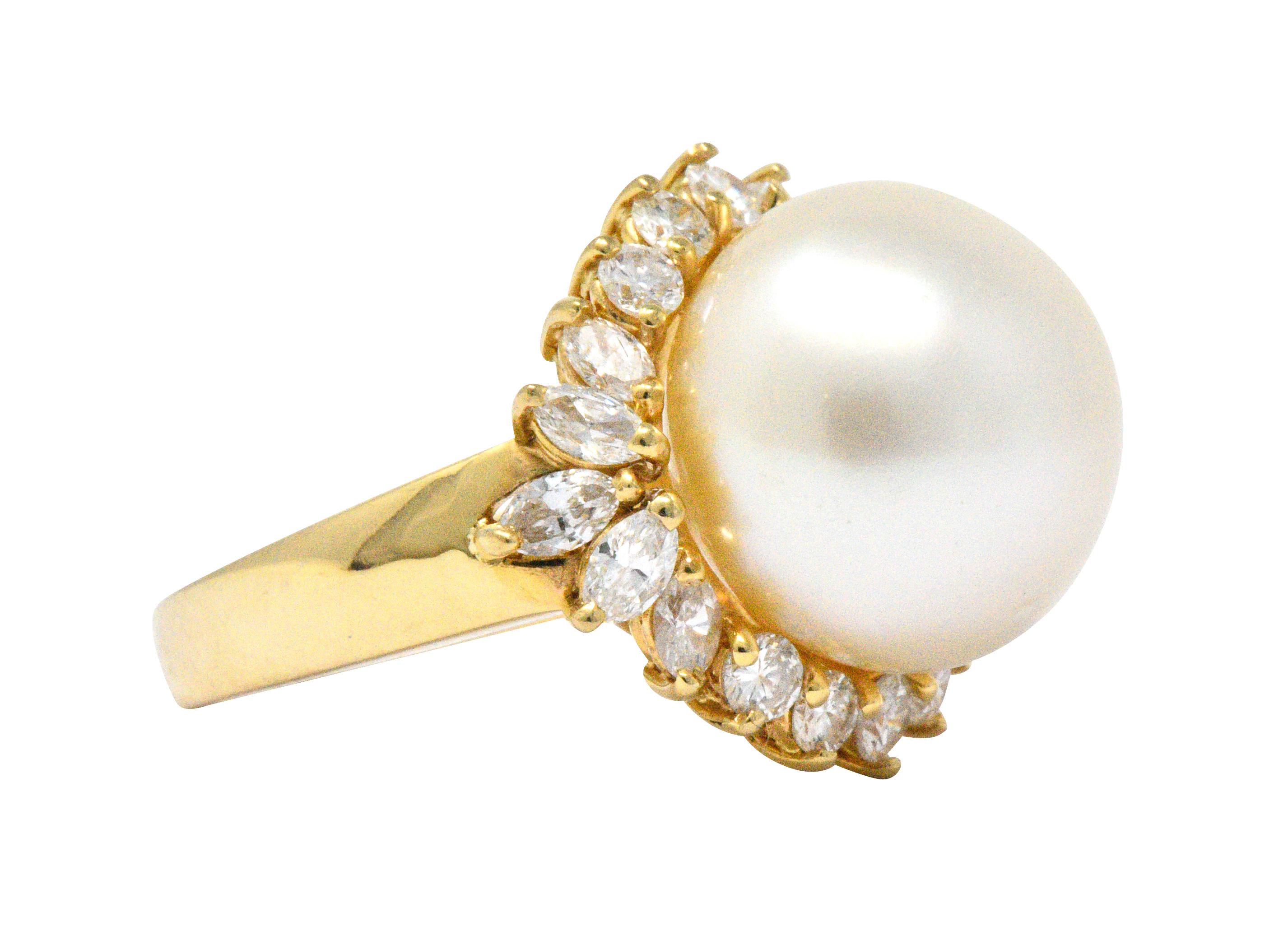 Centering a button shaped cultured South Sea Pearl measuring approximately 14.3 mm, cream body color

Featuring very good luster with slight rose overtones and very good surface quality

Accented by 10 marquise cut diamonds and 10 round brilliant