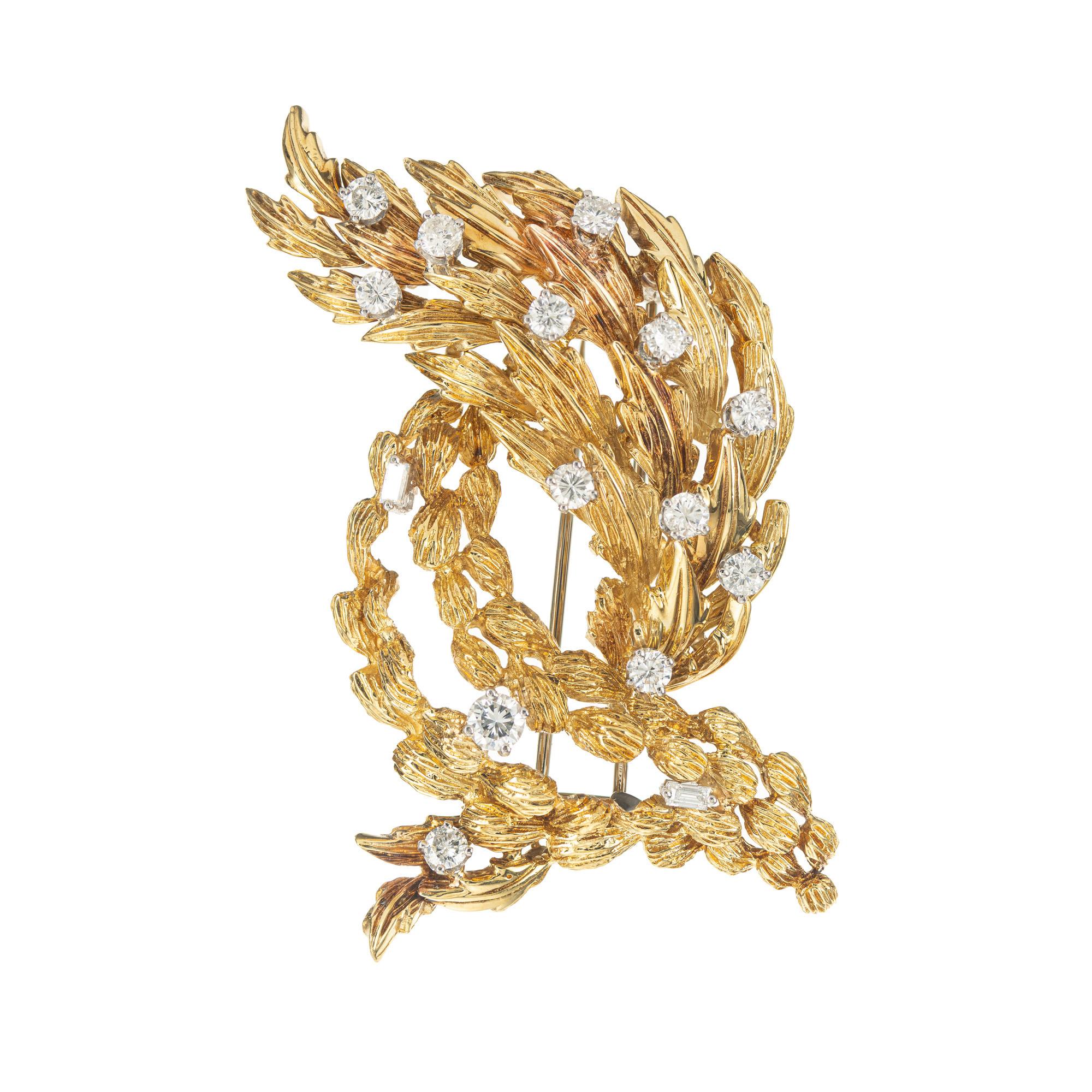 Vintage 1950s textured 18k yellow gold brooch with 2 hinged flexible sections set with brilliant cut and baguette Diamonds. Set with 13 round cut diamonds with a total carat weight of 1.25cts and accented by 2 baguette cut diamonds. This exquisite