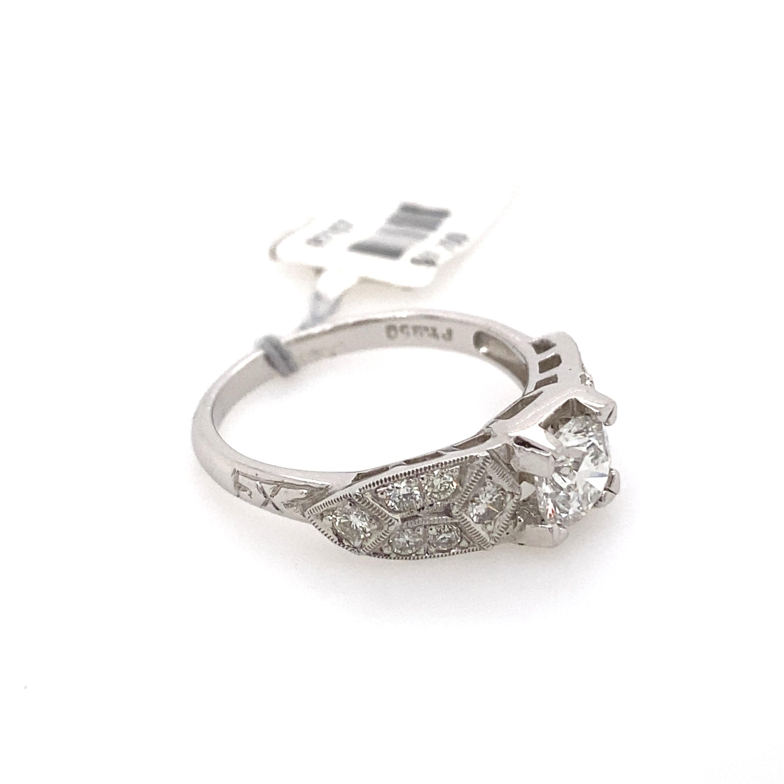 Edwardian style diamond ring with milgrain work. 
0.80ct center round brilliant diamond complimented with 0.50ct of round diamonds. 1.30ct total diamond weight. 18k white gold with milgrain and filigree work.
Accommodated with an up to date