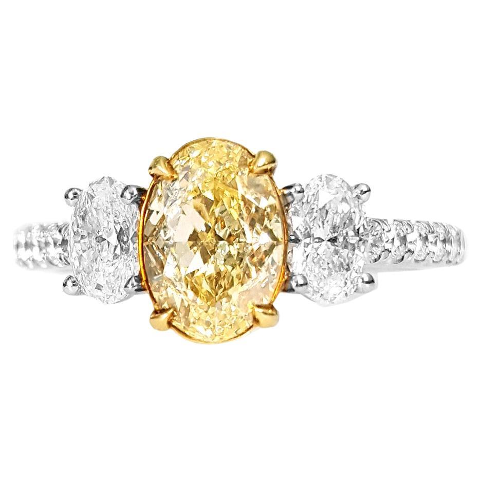 1.30 Carat Fancy Yellow Oval Diamond Three-Stone Engagement Ring, GIA Certified. For Sale