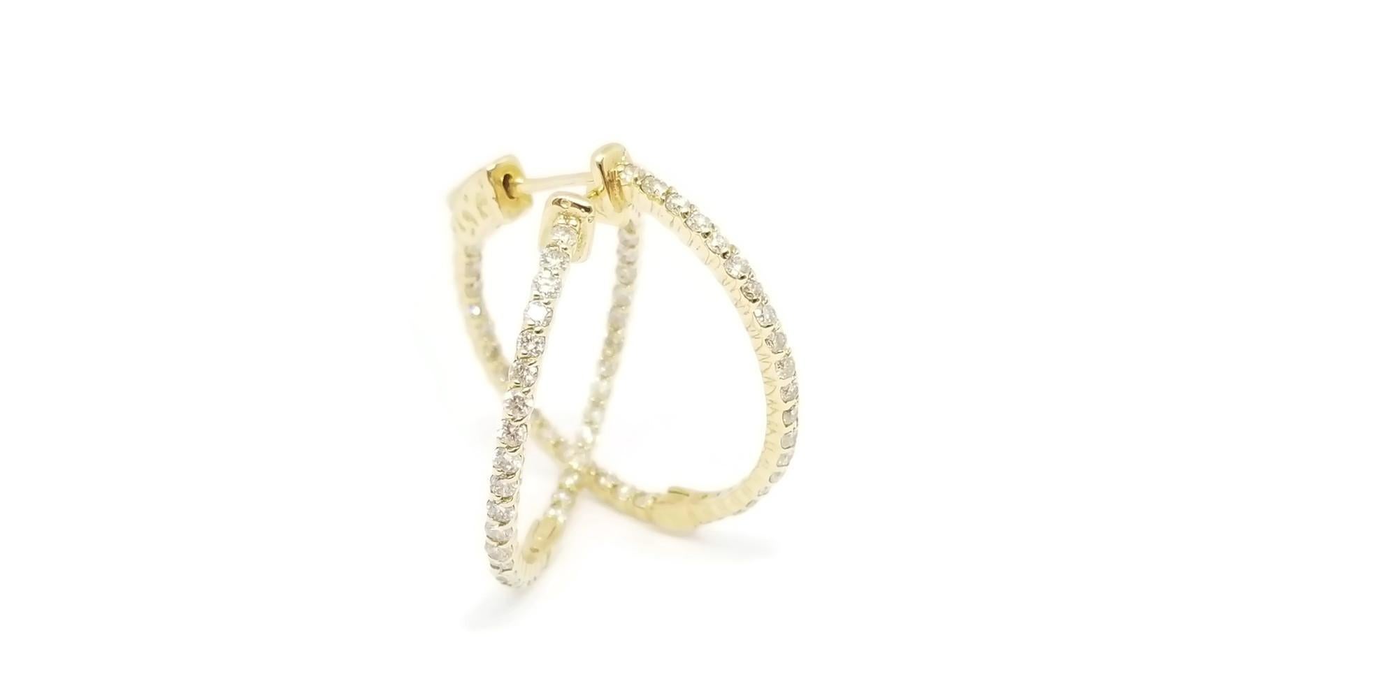 Beautiful pair of huggie diamond inside out hoop earrings in 14K Yellow gold. Secures with snap closure for wear. Color H, Clarity SI, Measures 1 inch in diameter. 