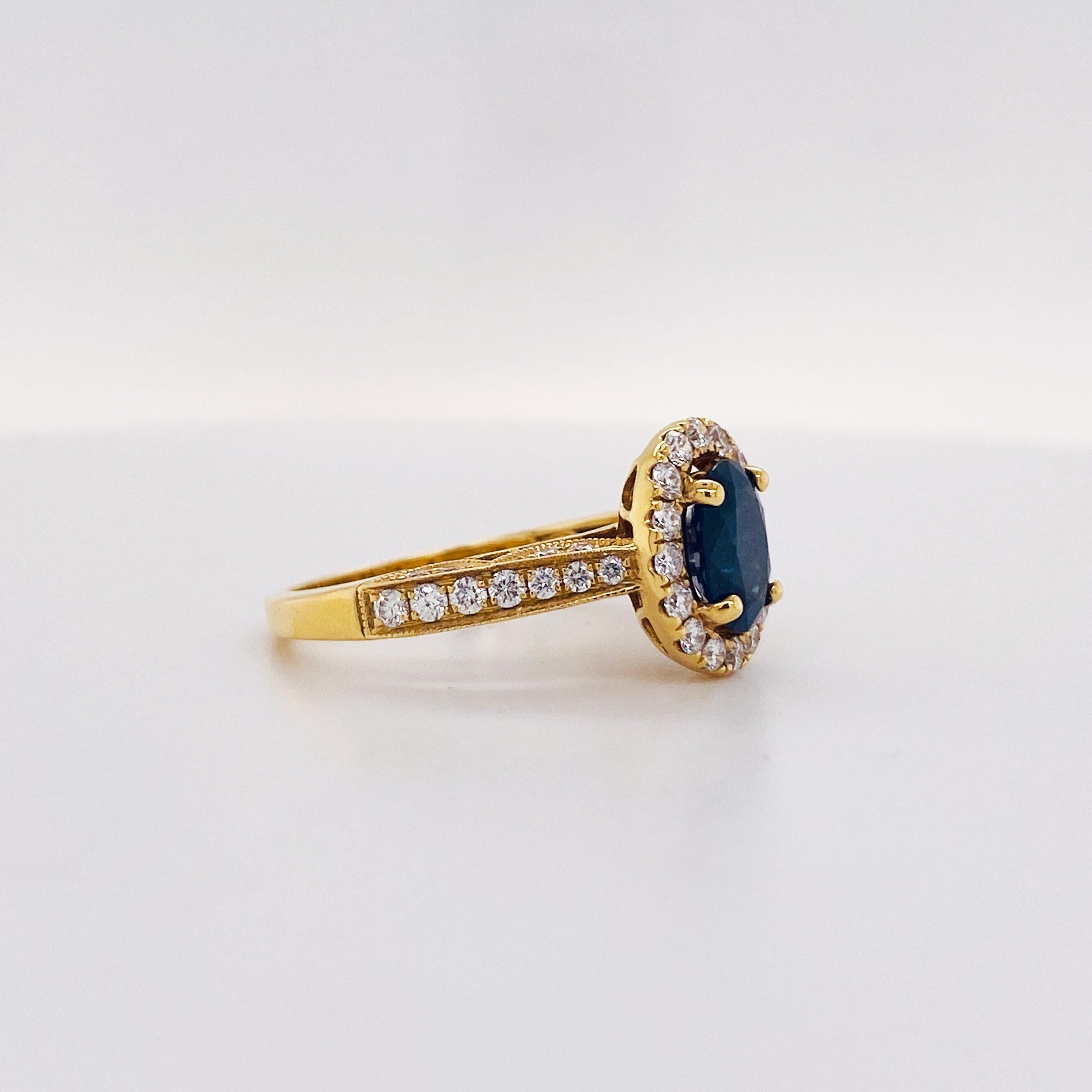 Bold & Beautiful - This 1.30 carat Deep Blue Sapphire looks amazing in the rich, 18k yellow gold! Framed with a bright white diamond halo, with diamonds of VS clarity and G-H color grades. The deep blue contrasts with the bright white diamonds and