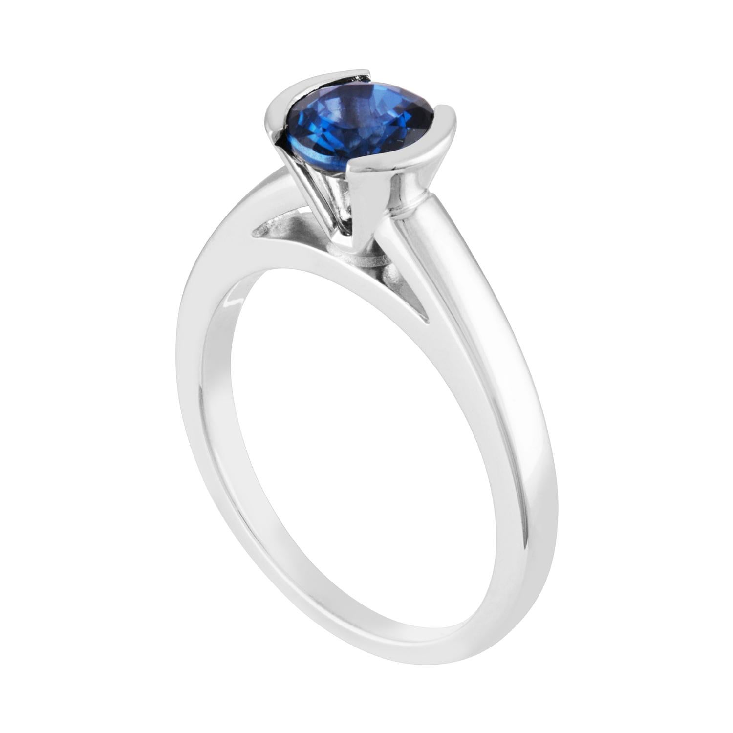 Solitaire Half Bezel Engagement Ring
The ring is 14K White Gold
The Blue Sapphire is a round 1.30 Carat Heated
The ring is a size 7.00, sizable.
The ring weighs 4.5 grams