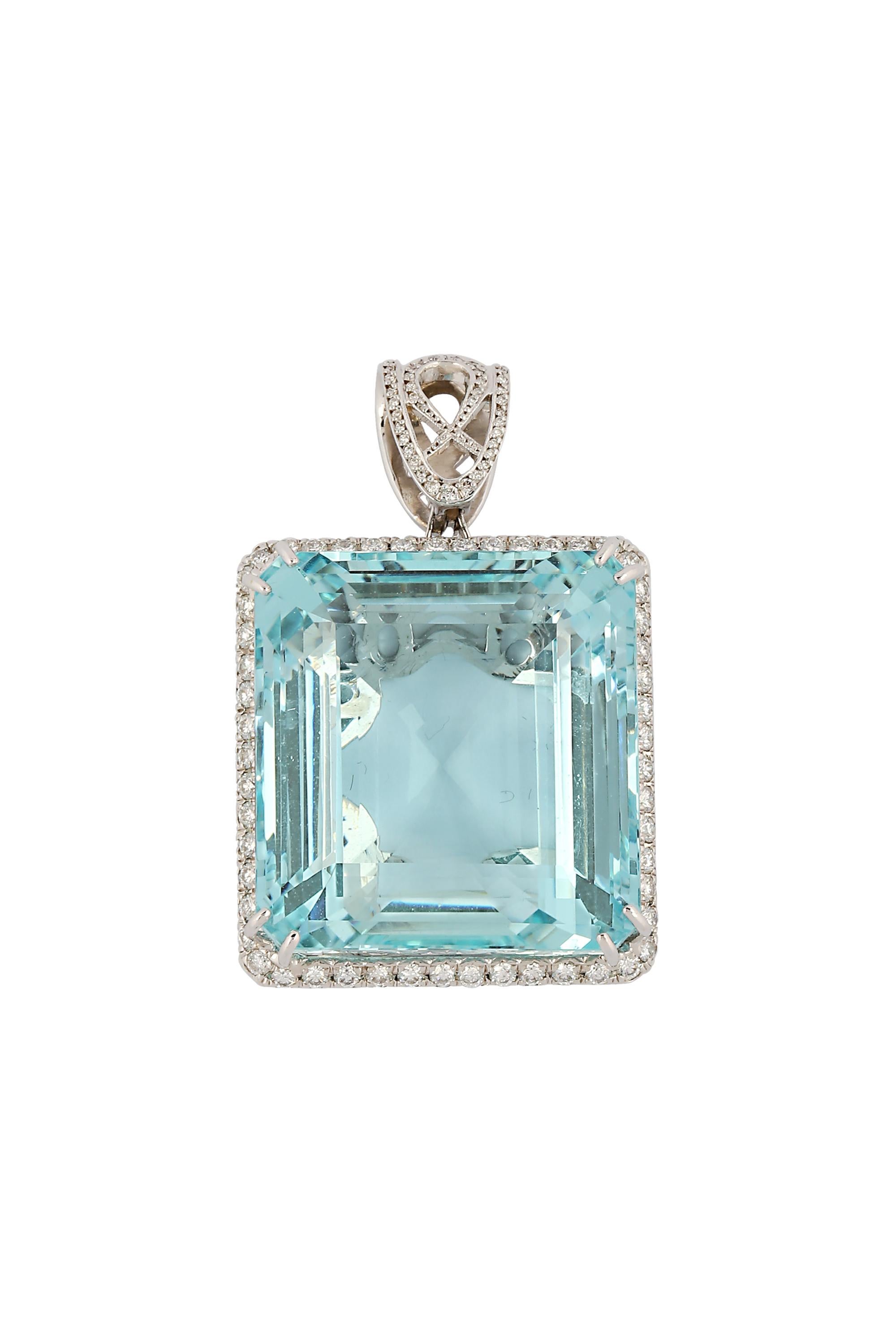 A rare and deep blue aquamarine is the stunning center of this beautifully crafted pendant. This exceptional stone, weighing approximately 130 carats, is unusually clean for its size. The aquamarine is enhanced by a frame of glittering pave diamonds